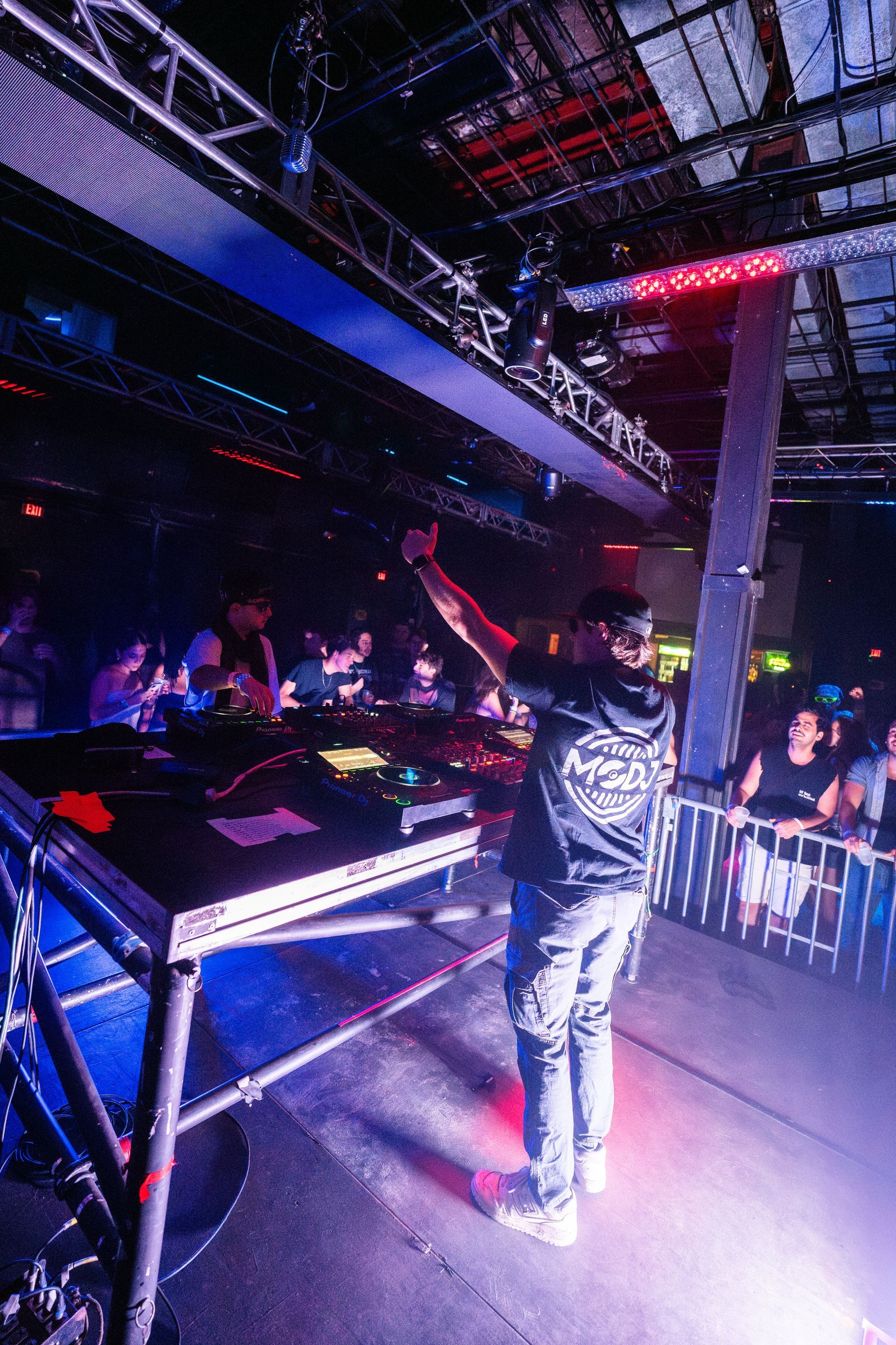 A man is standing on a stage in front of a crowd at a concert.