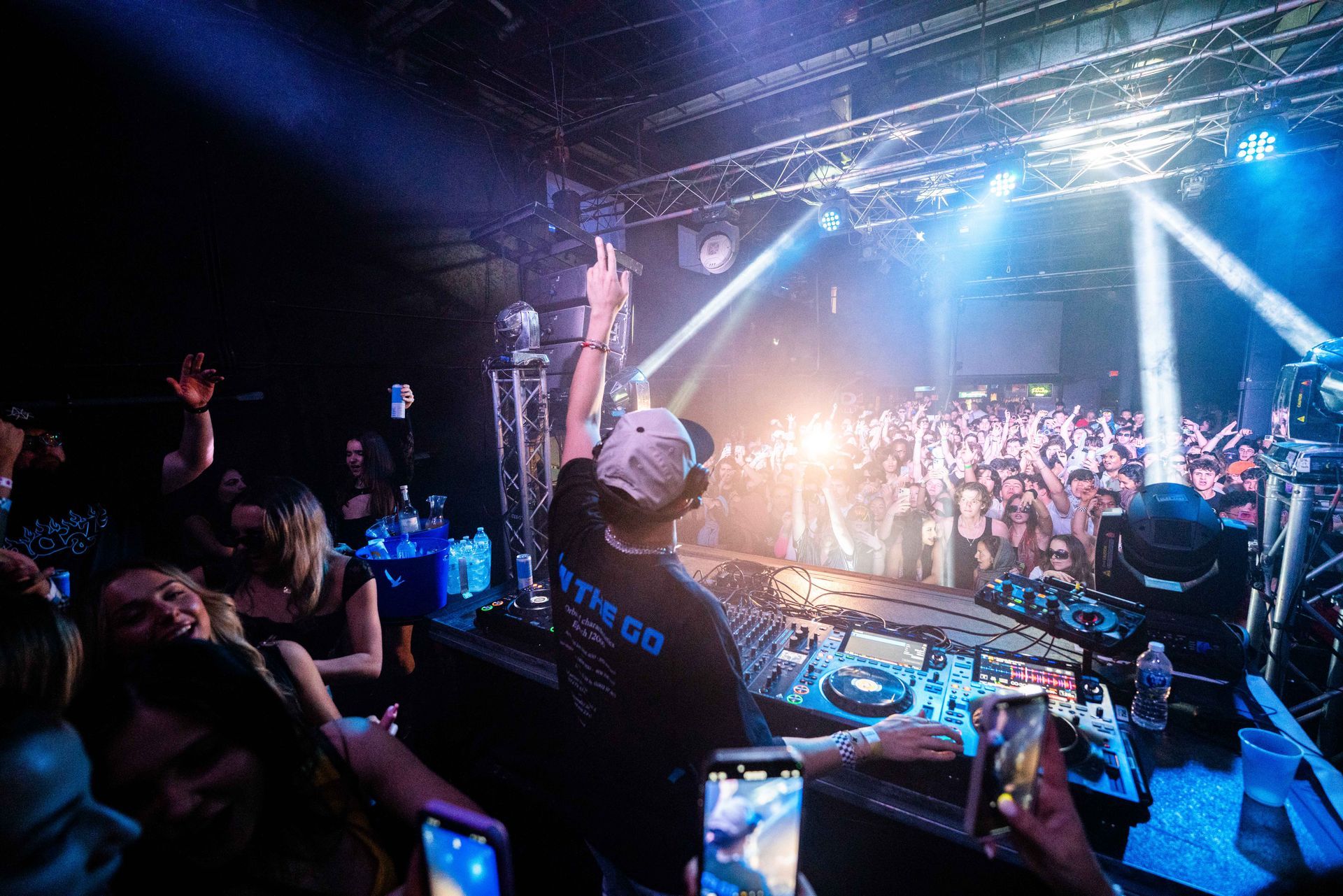 A dj is playing music in front of a crowd at a concert.