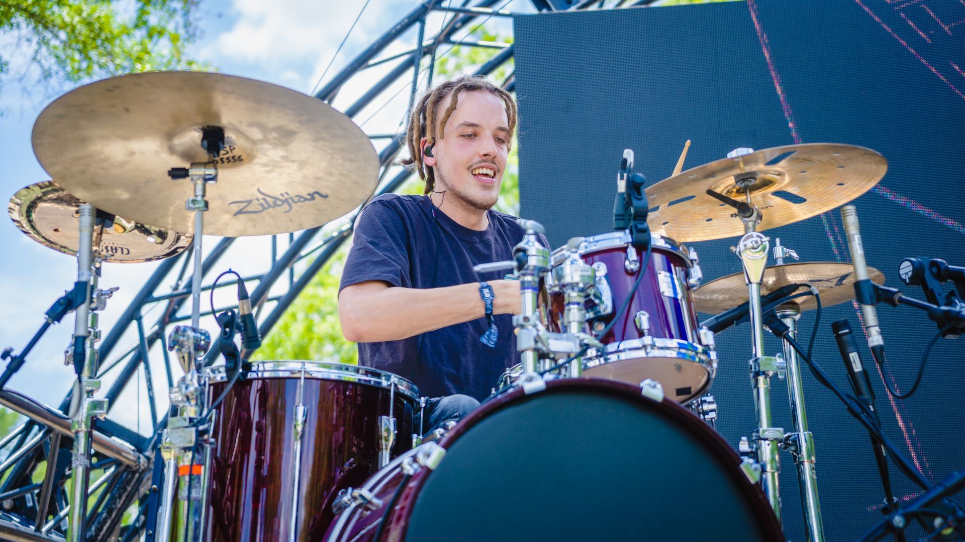 A man is playing drums on a stage.