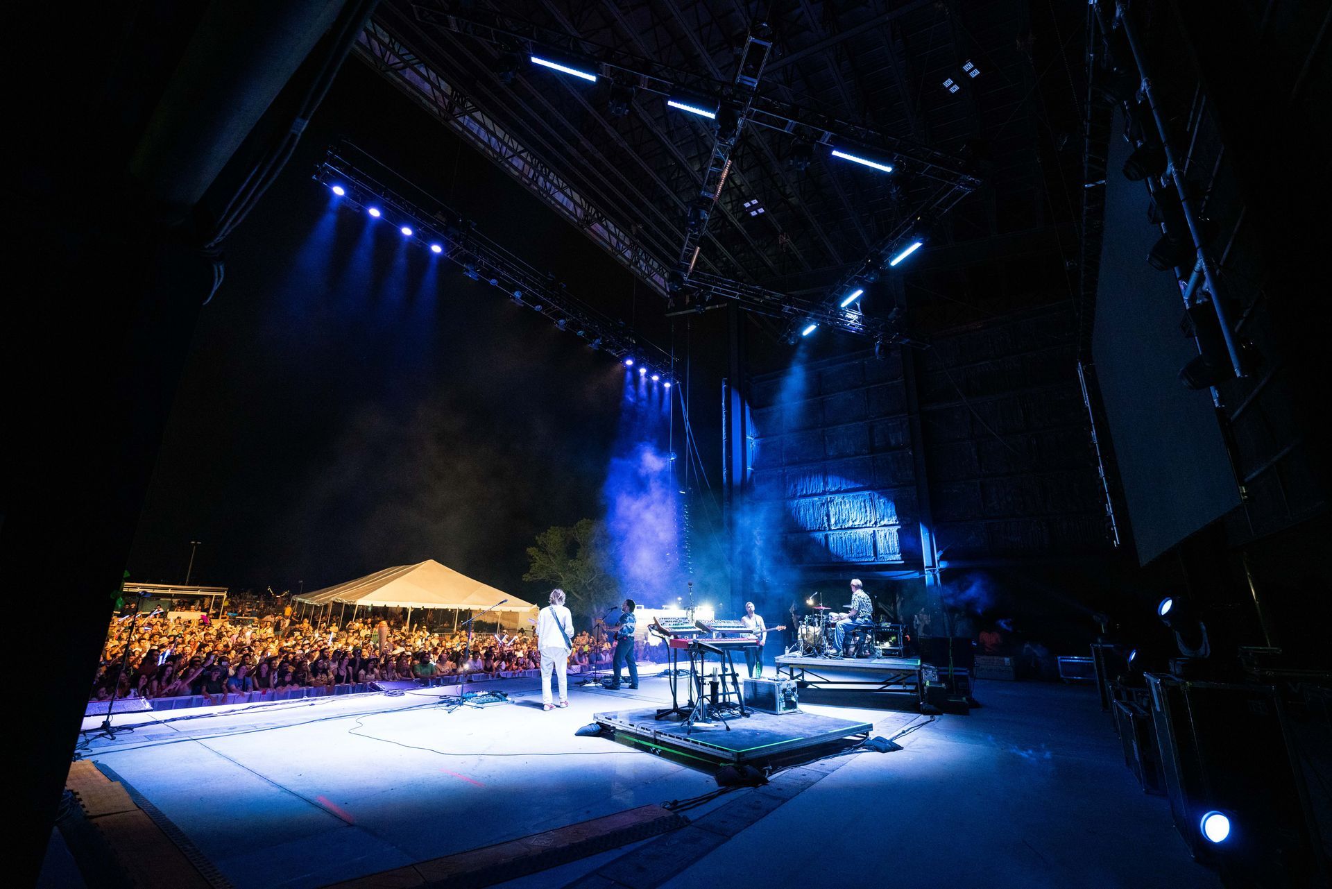 A group of people are standing on a stage in front of a crowd.