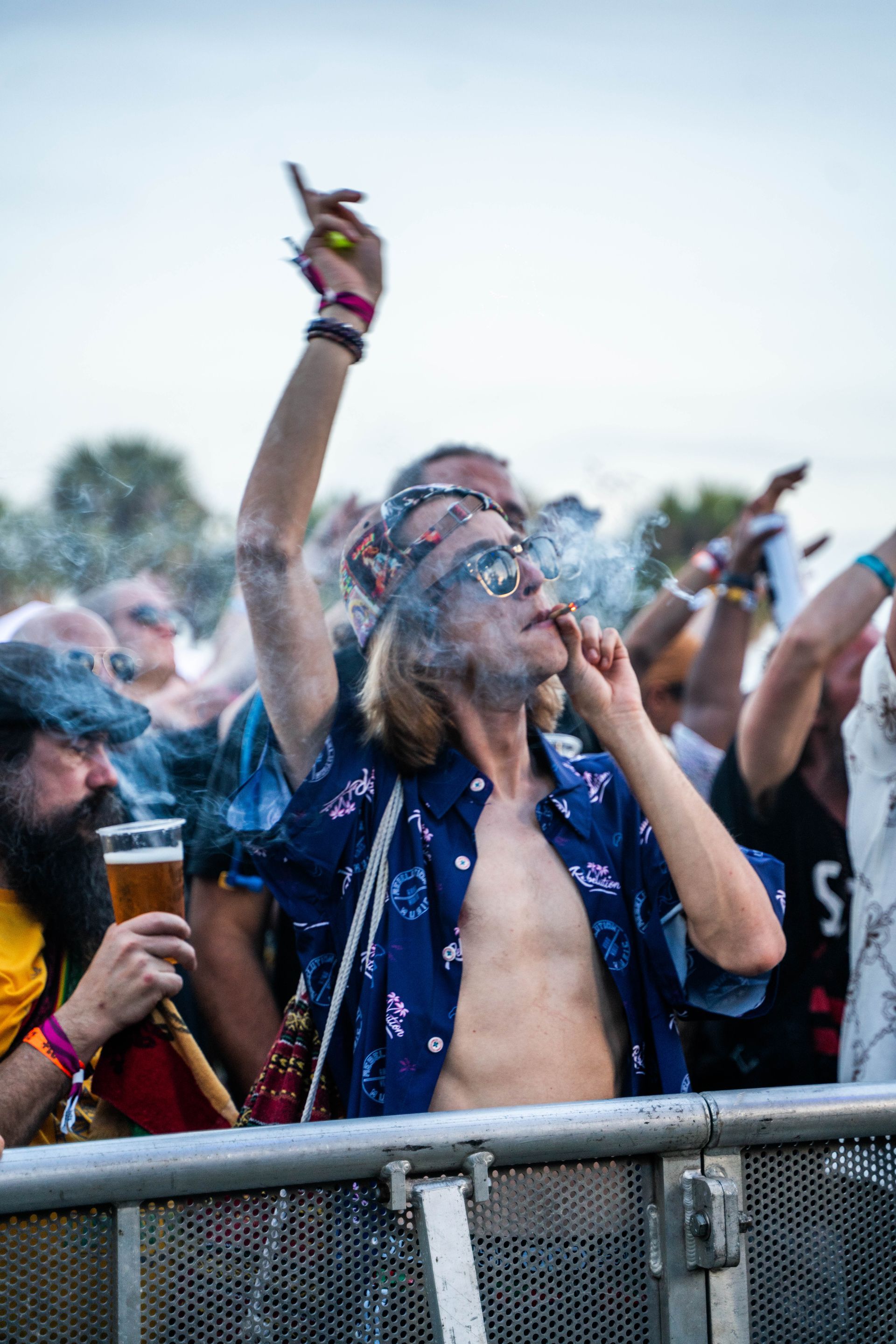 Concert goer smoking while enjoying music.