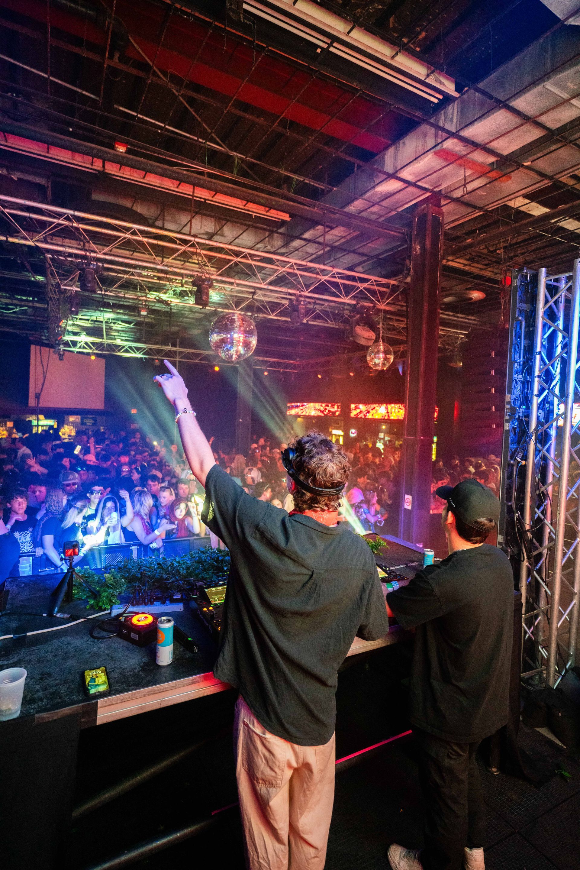 Two men are standing in front of a crowd at a concert.