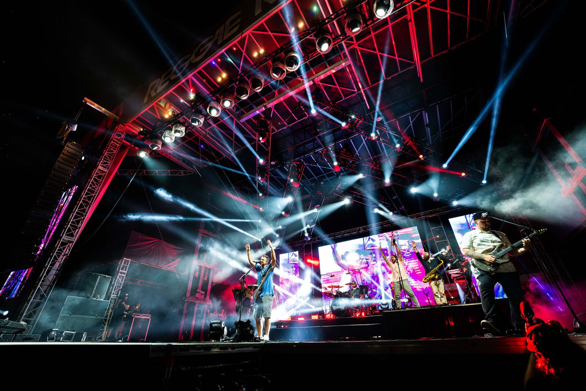 A group of people are playing instruments on a stage at a concert.
