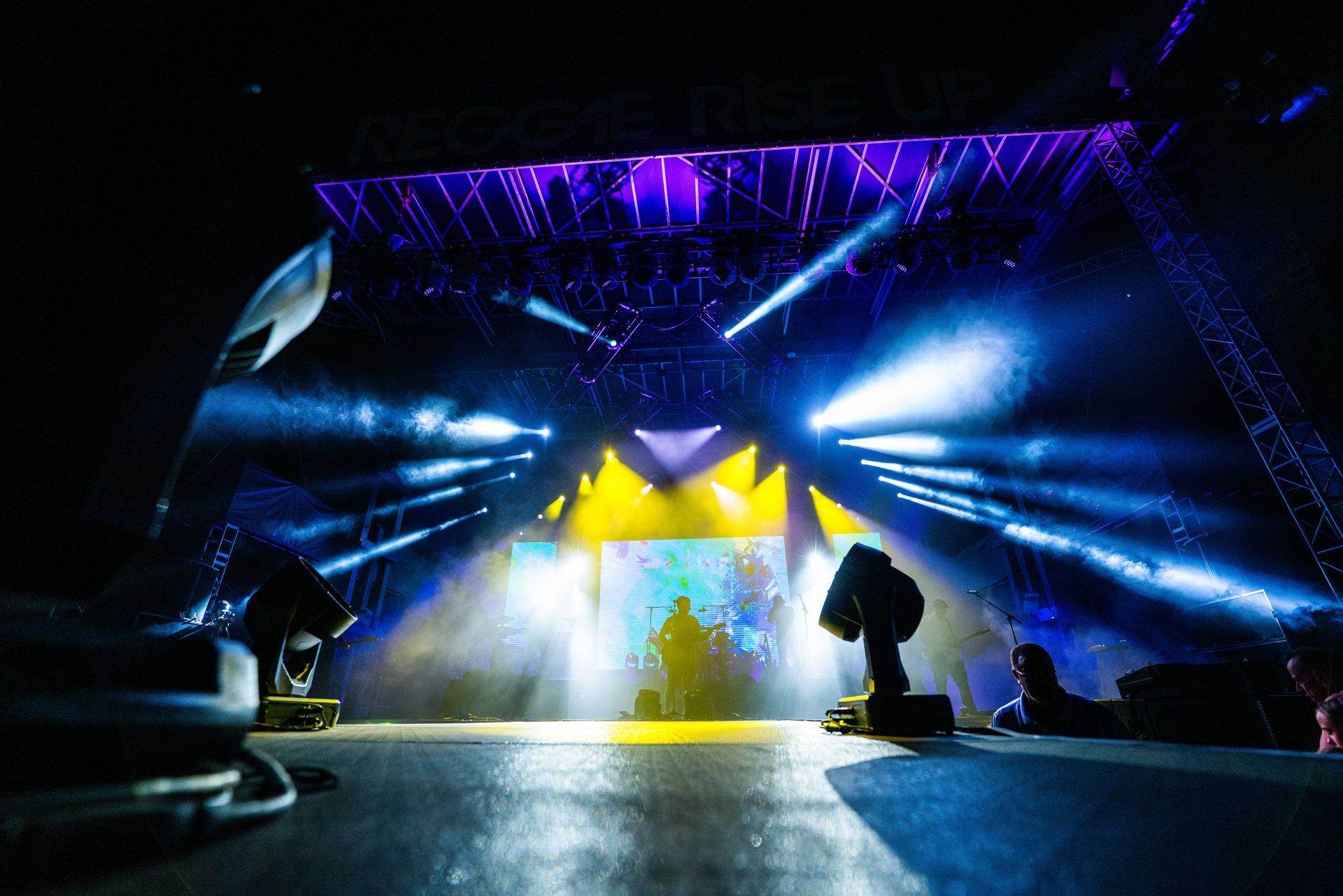 A stage with a lot of lights and smoke coming out of it.