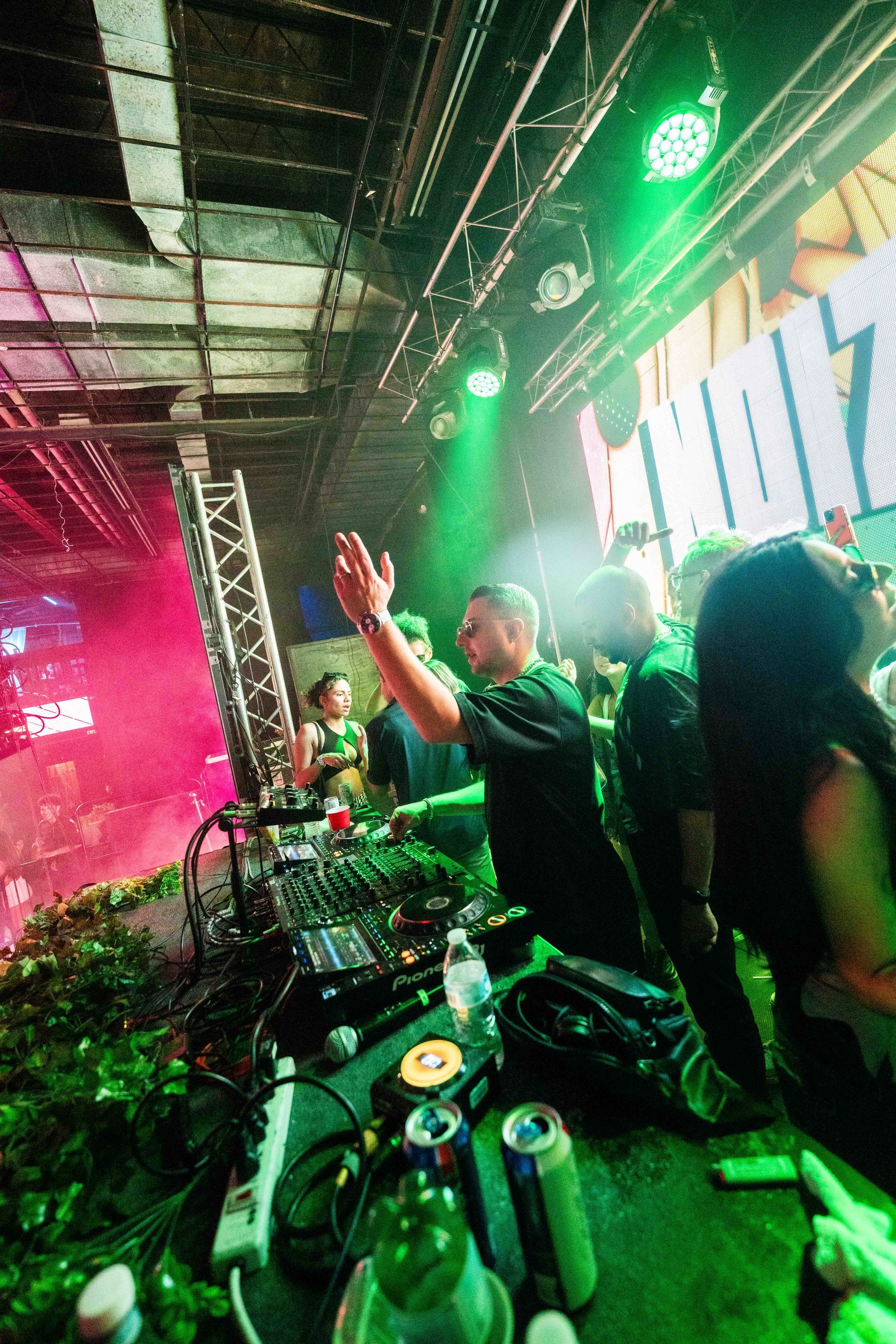 A group of people are standing in front of a stage at a concert.