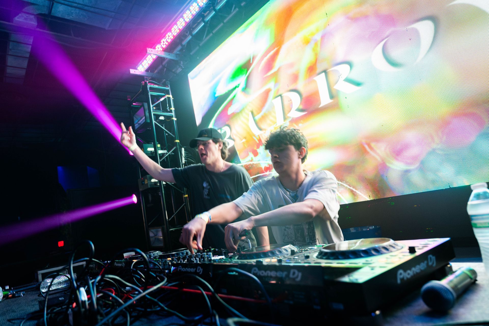 A couple of men are playing music on a stage.