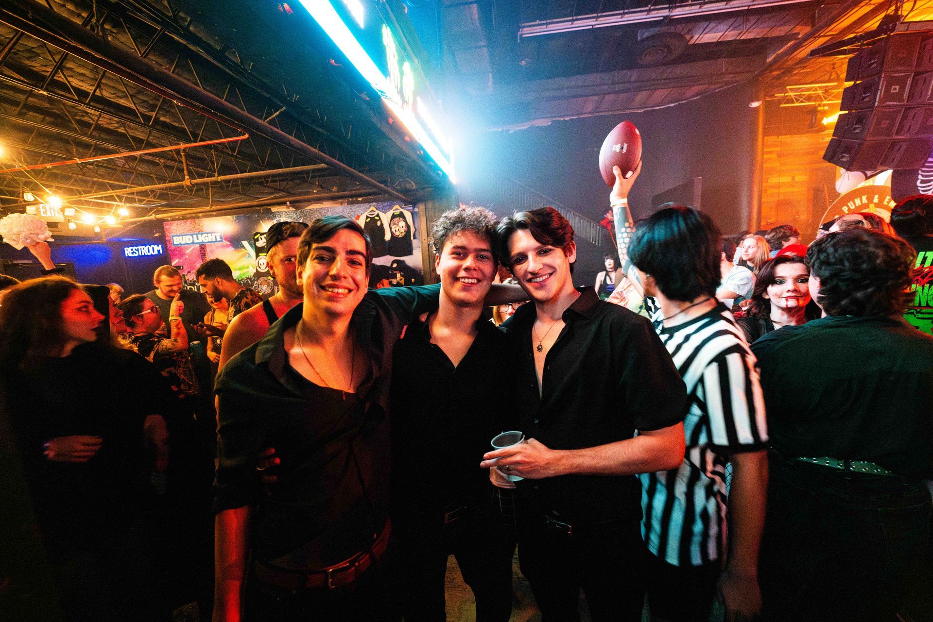 A group of people are posing for a picture in a club.