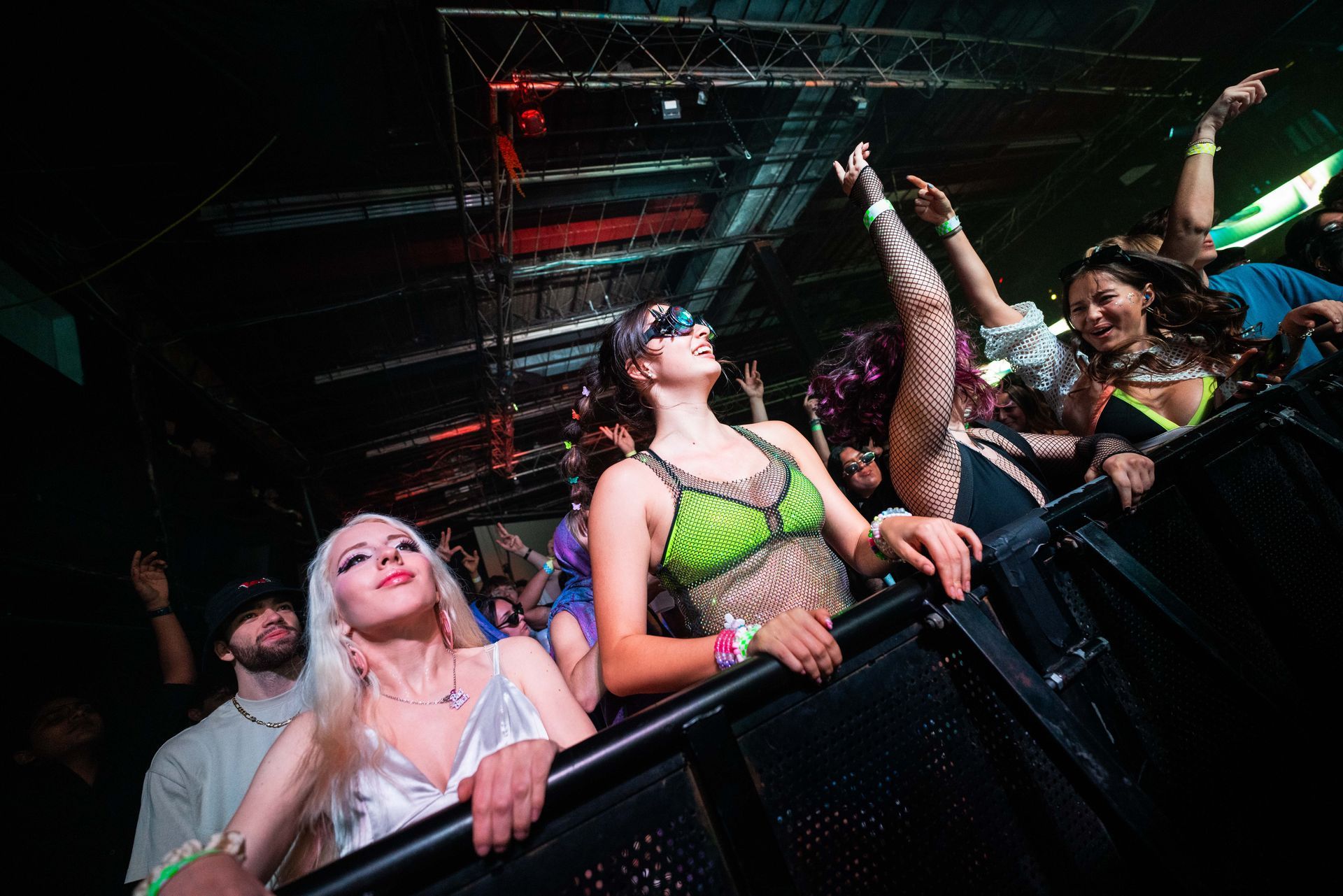 A group of people are standing in a crowd at a concert.