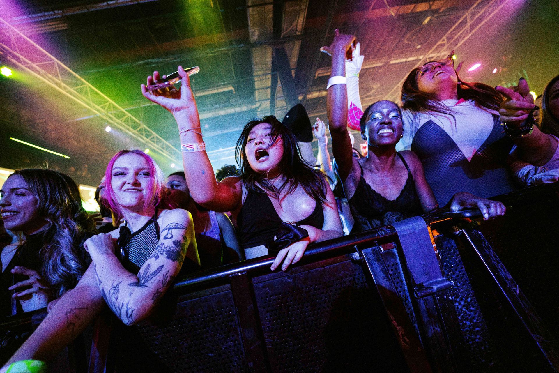 A group of people are sitting in a crowd at a concert.