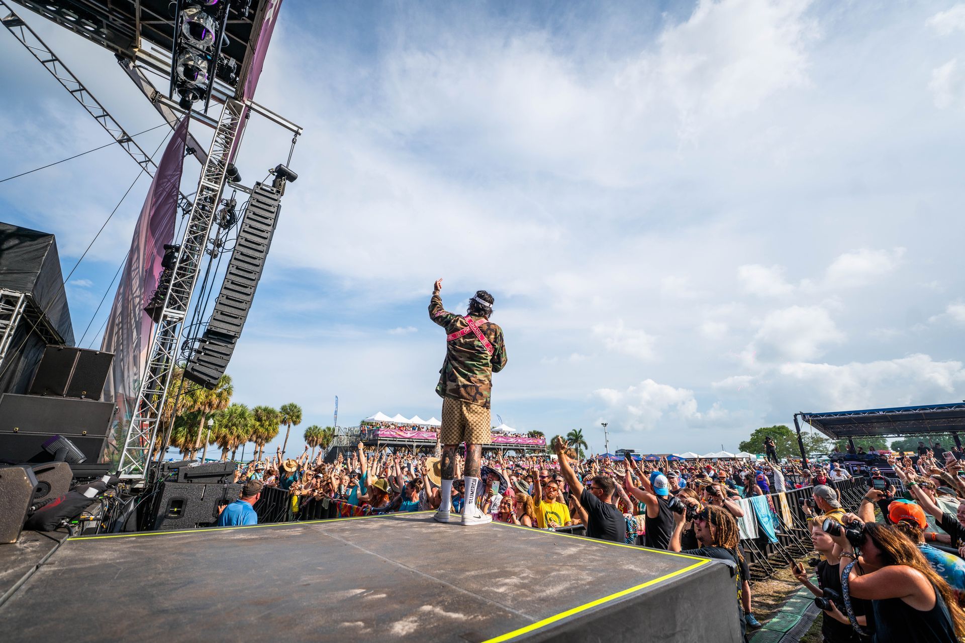 A man is standing on a stage in front of a crowd.