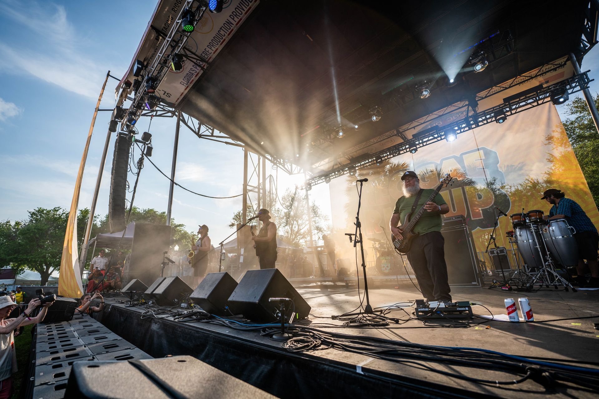 A group of people are playing instruments on a stage at a concert.