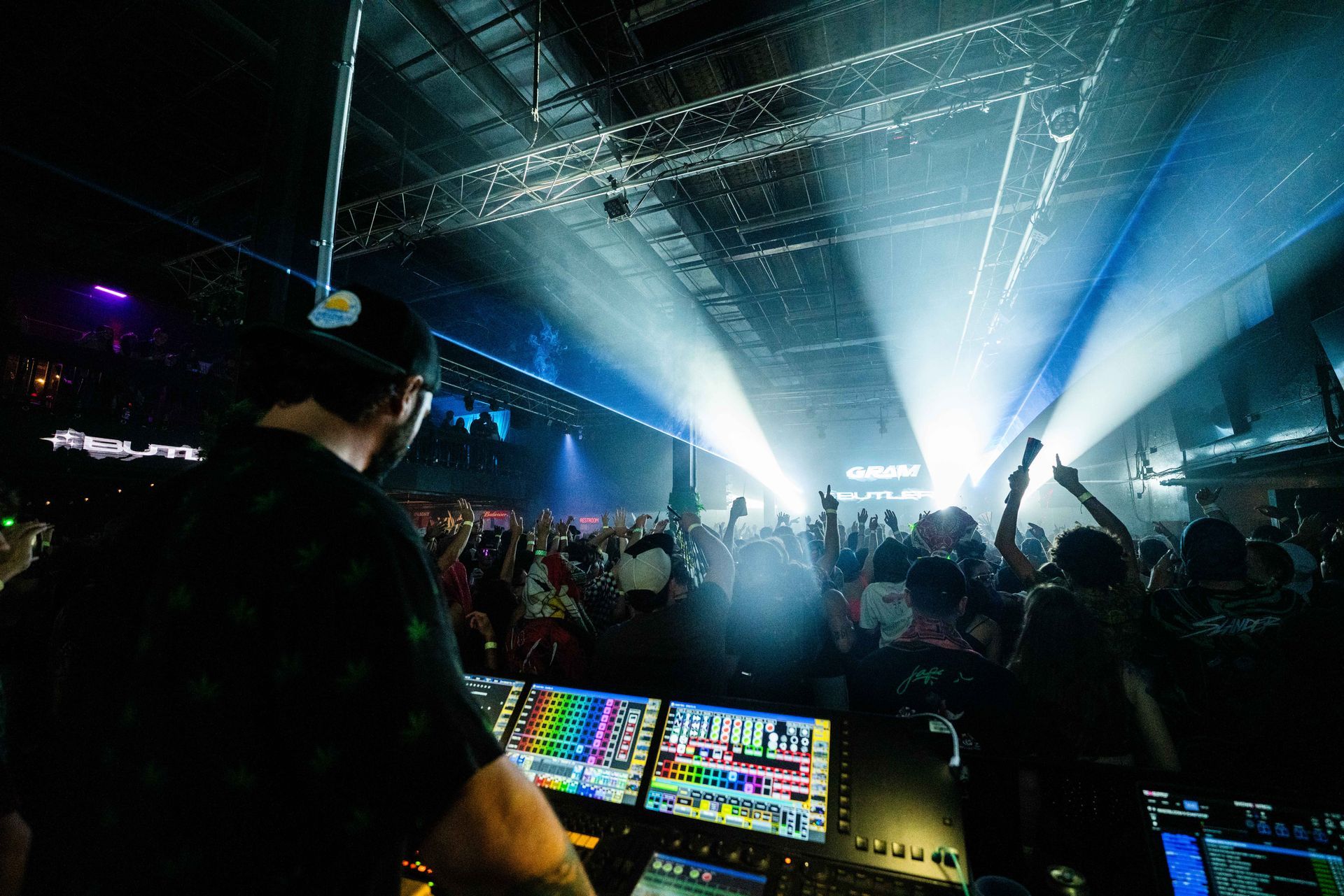 A dj is playing music in front of a crowd at a concert.