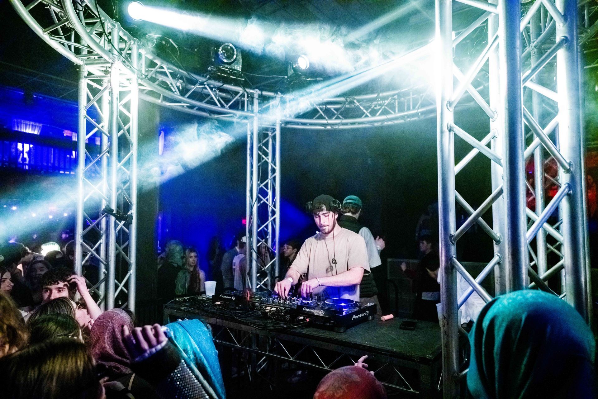 A man is playing music on a stage in front of a crowd.
