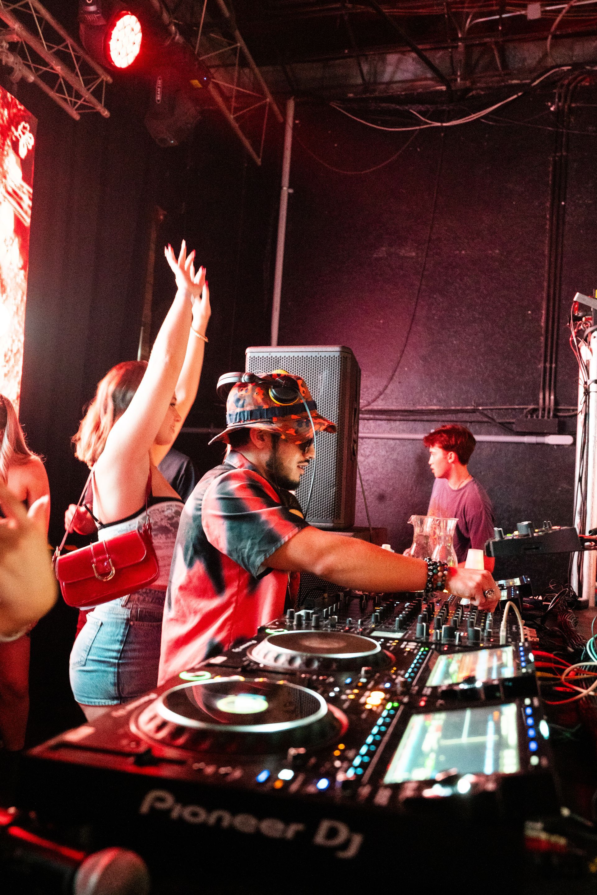 A man is playing music on a pioneer dj machine