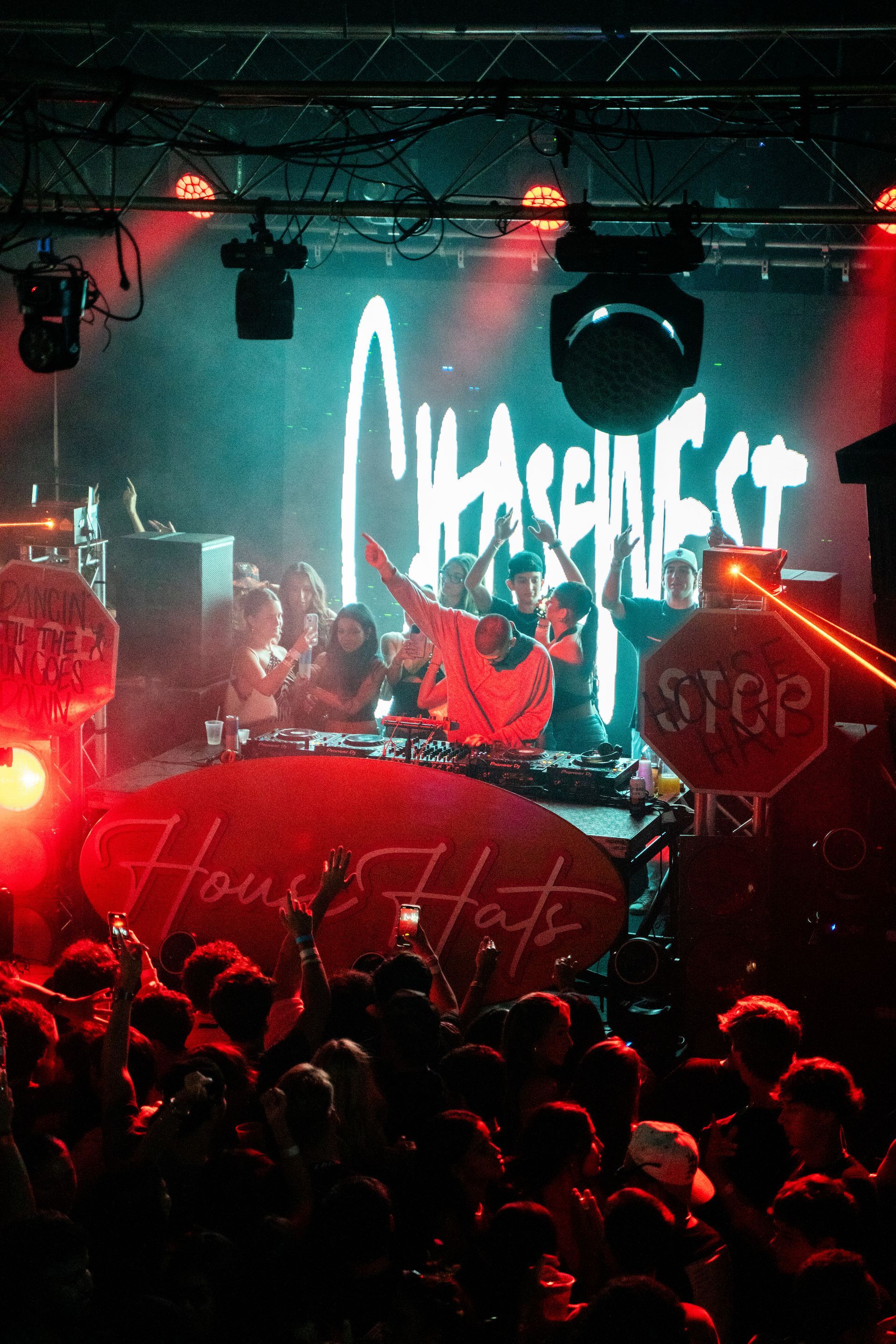 A group of people are standing in front of a stage at a concert.