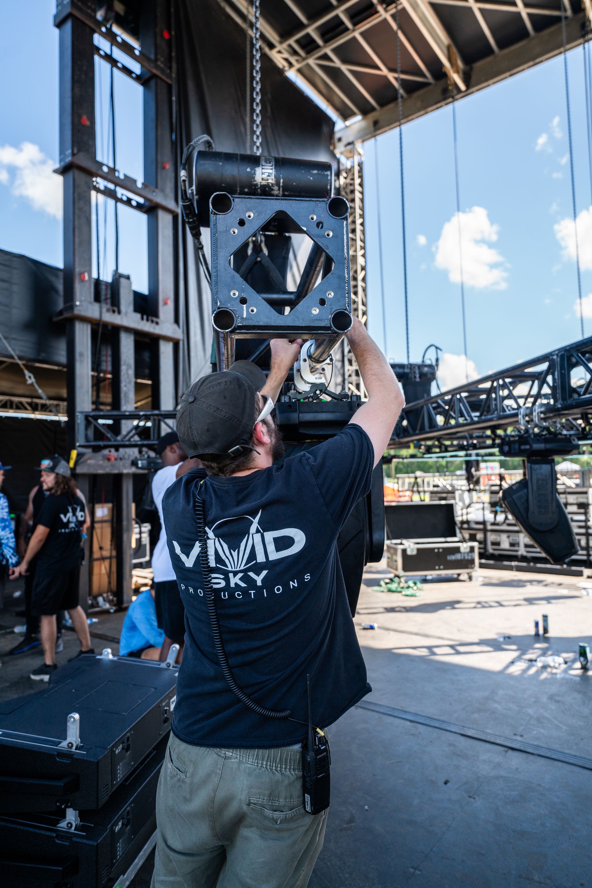A man in a blue shirt is working on a stage.
