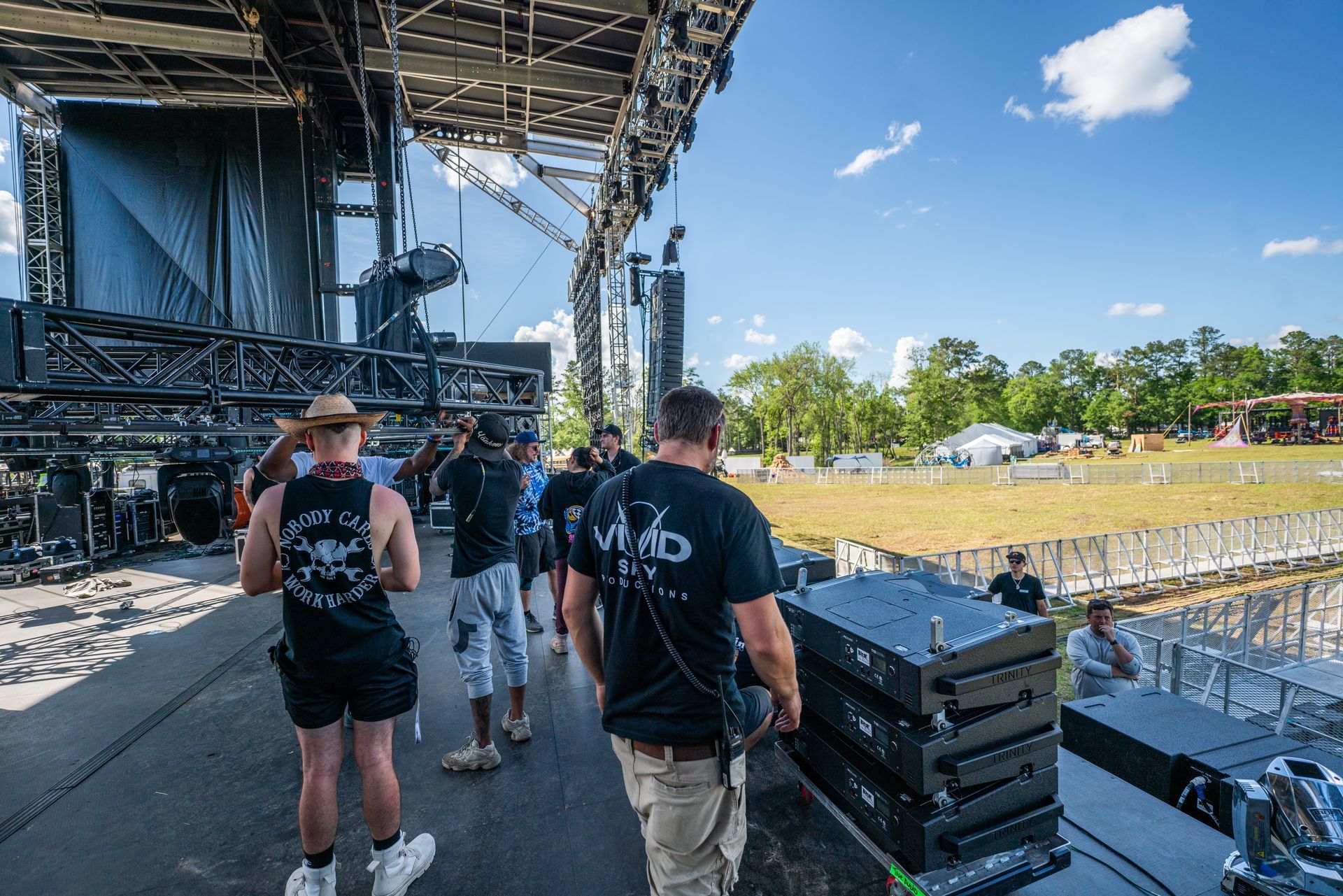 A group of people are standing in front of a stage.