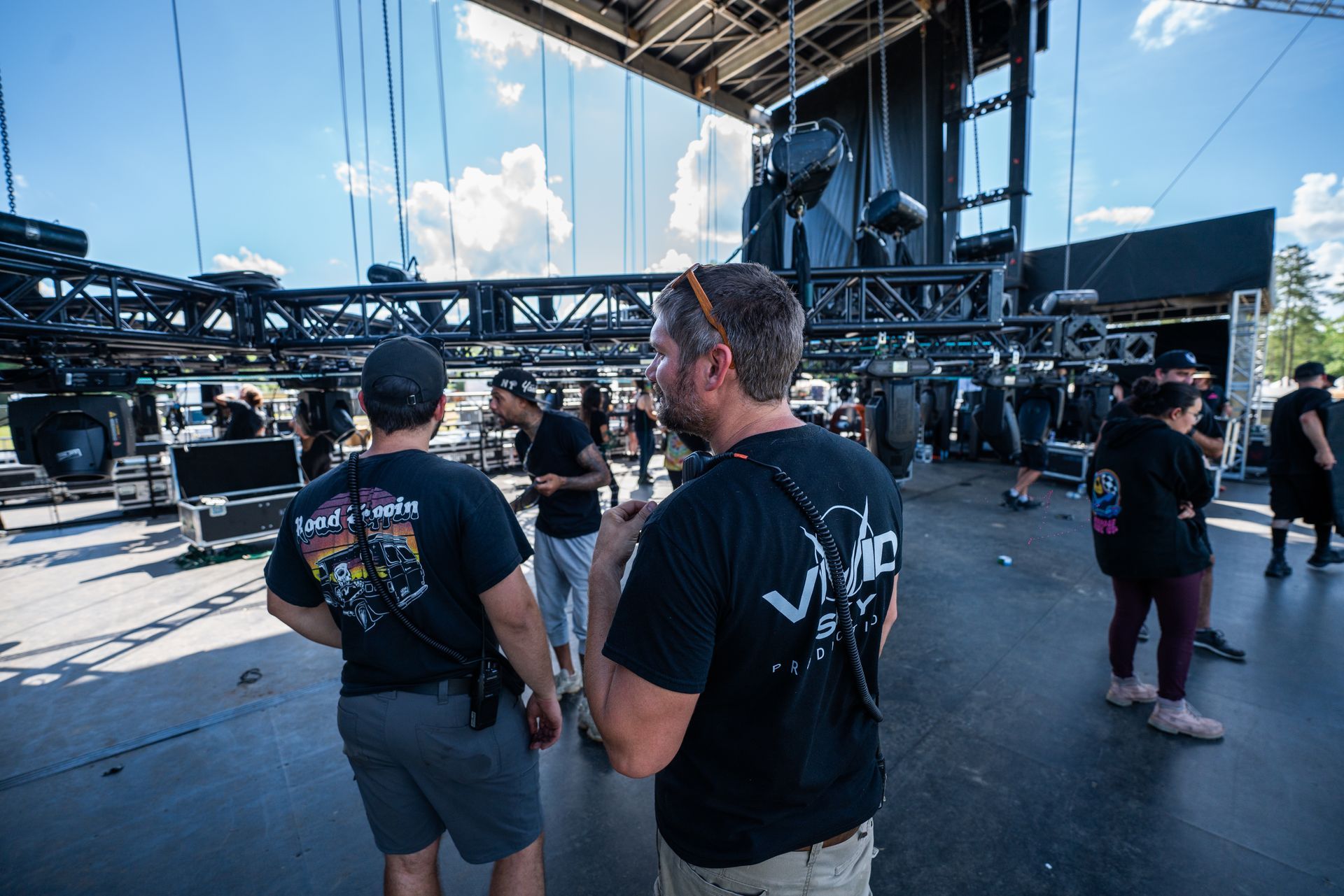 A group of men are standing in front of a stage.