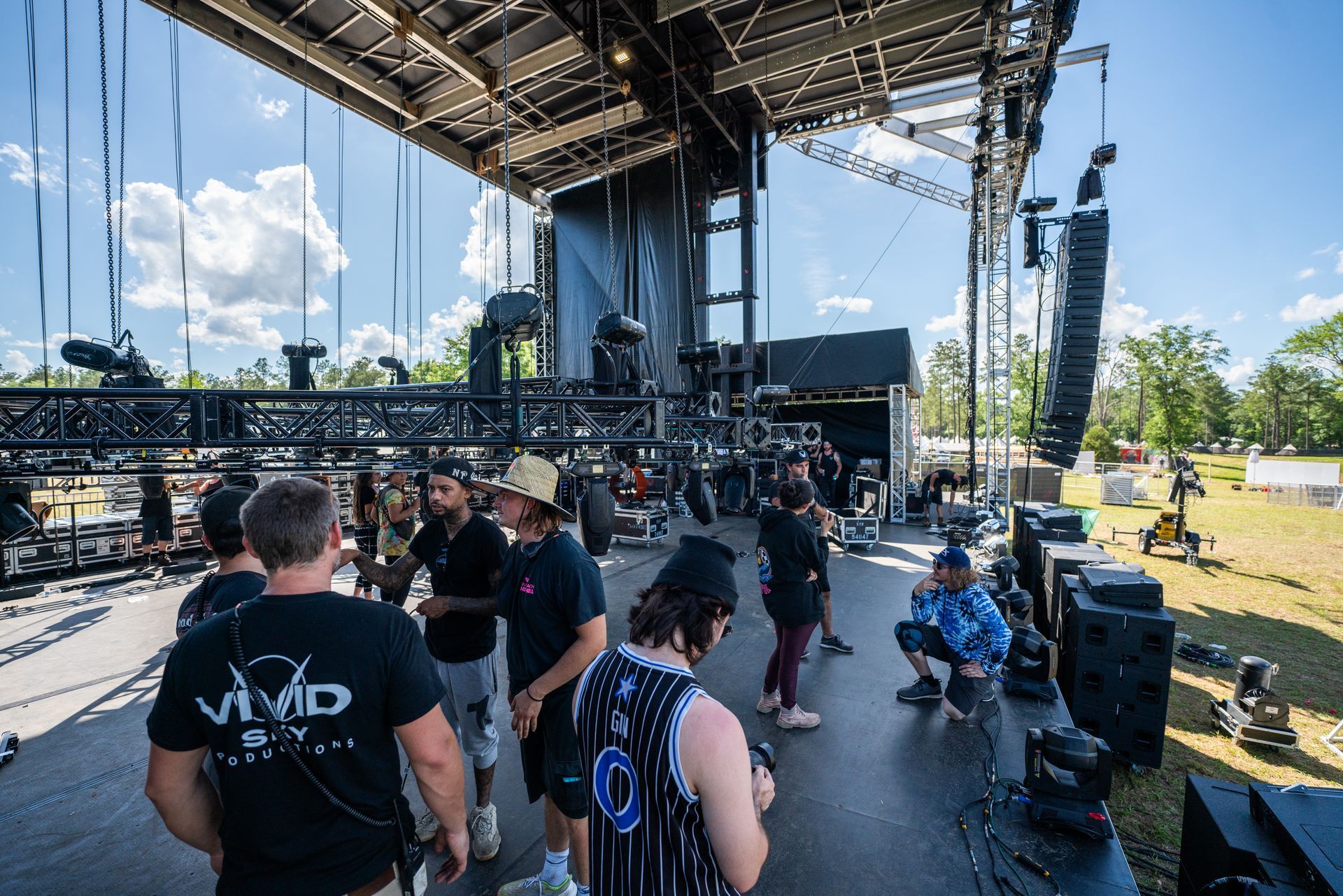A group of people are standing in front of a stage at a concert.