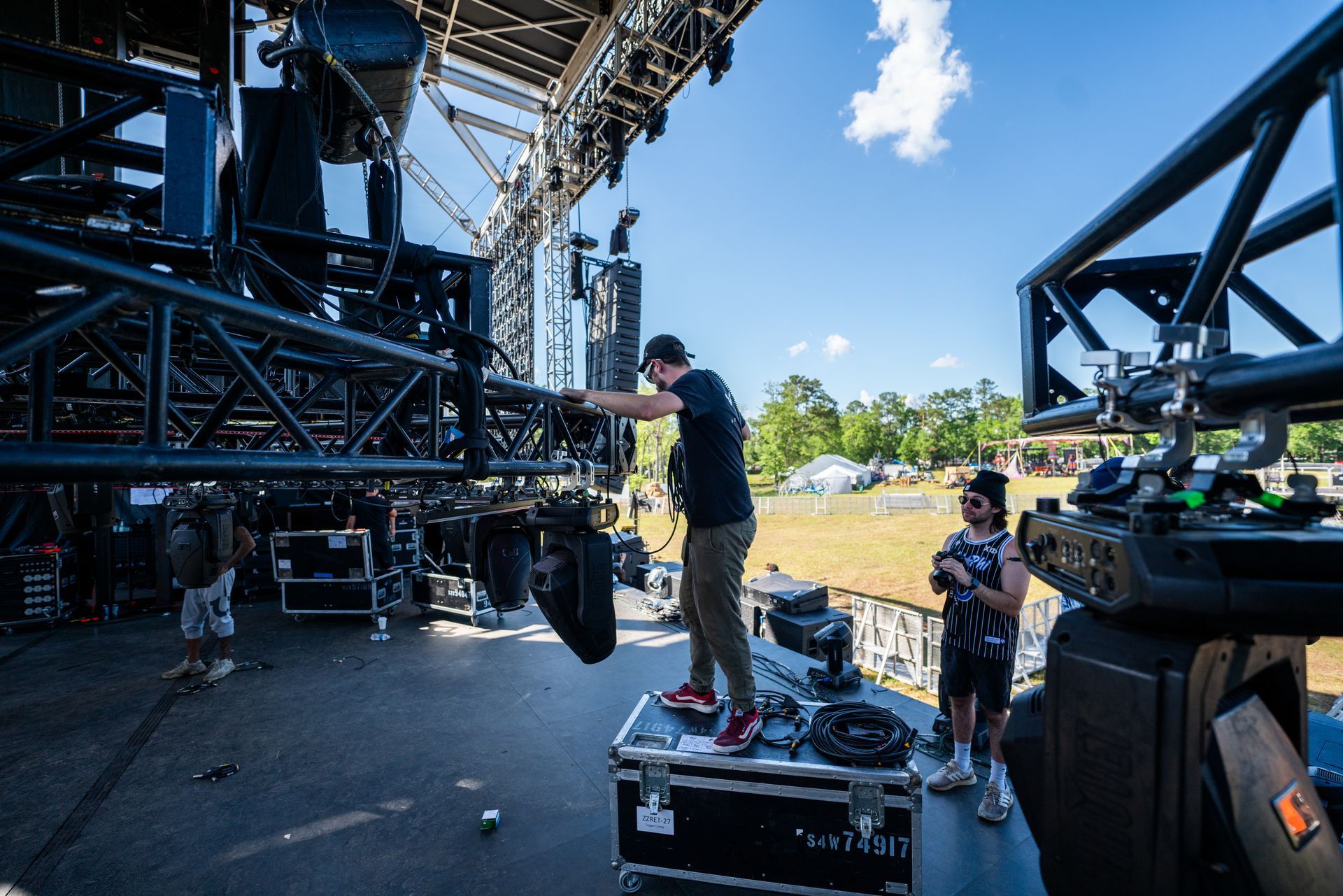 A man is working on a stage with a camera.