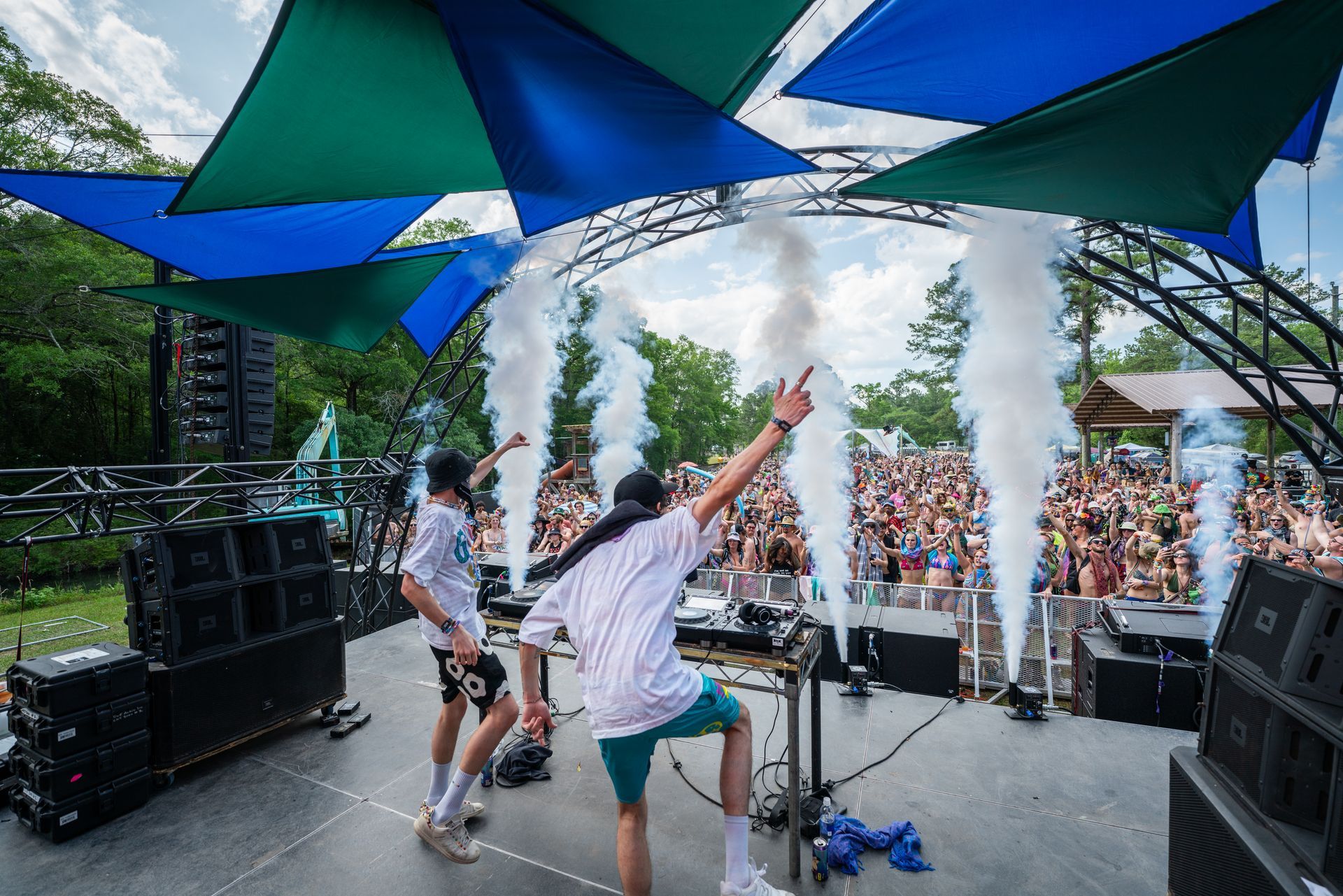 A group of people are standing on a stage in front of a crowd.
