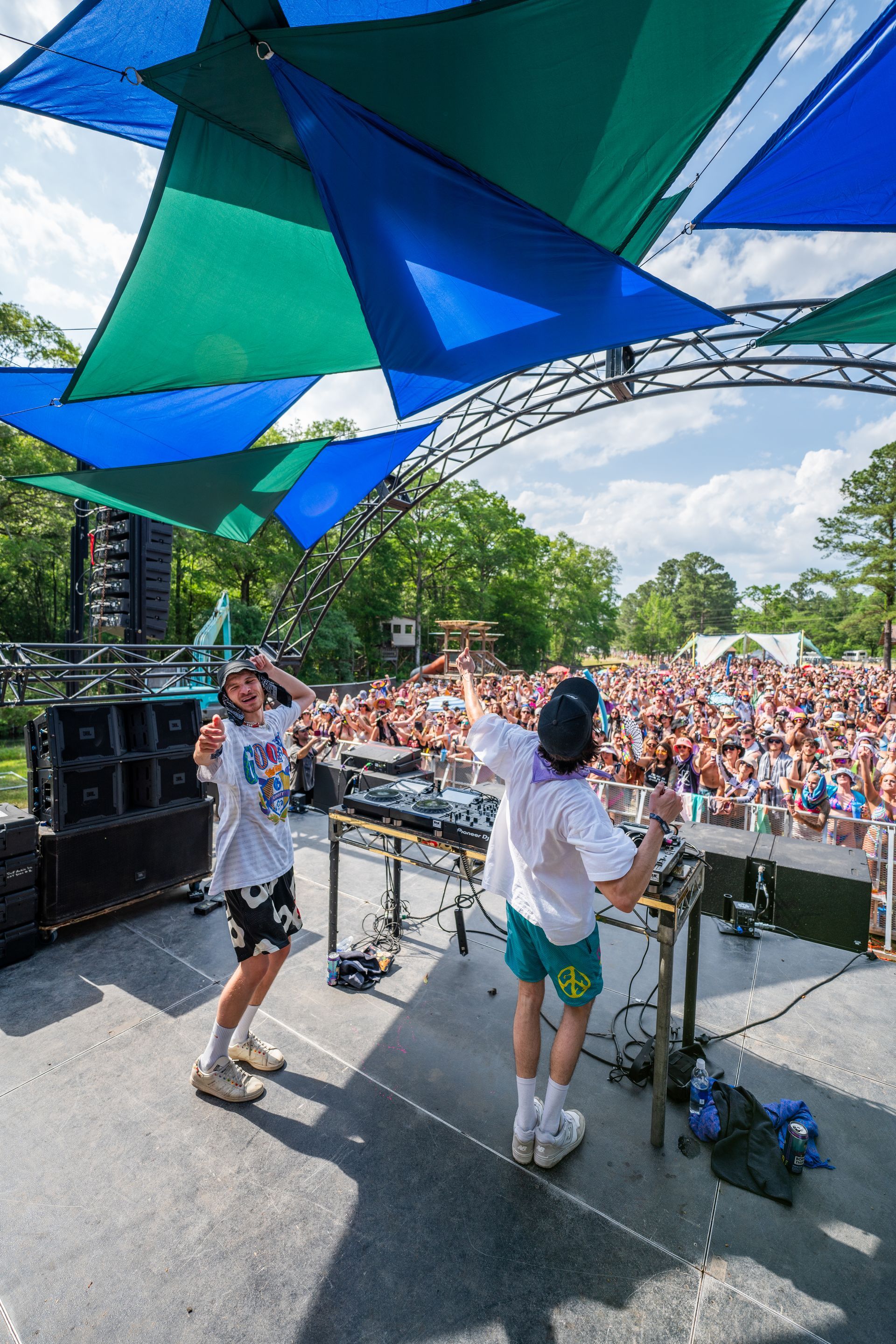 A couple of people are standing on a stage in front of a crowd.