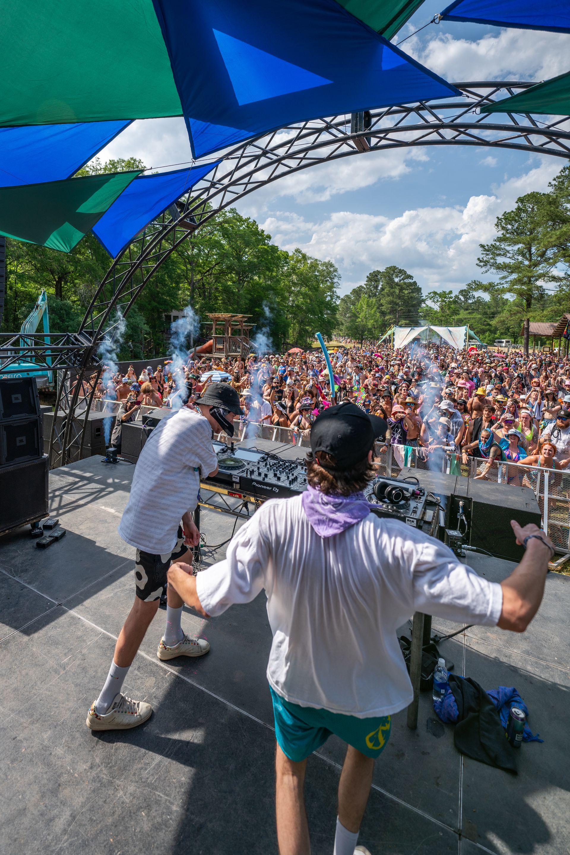 A group of people are standing on a stage in front of a crowd.