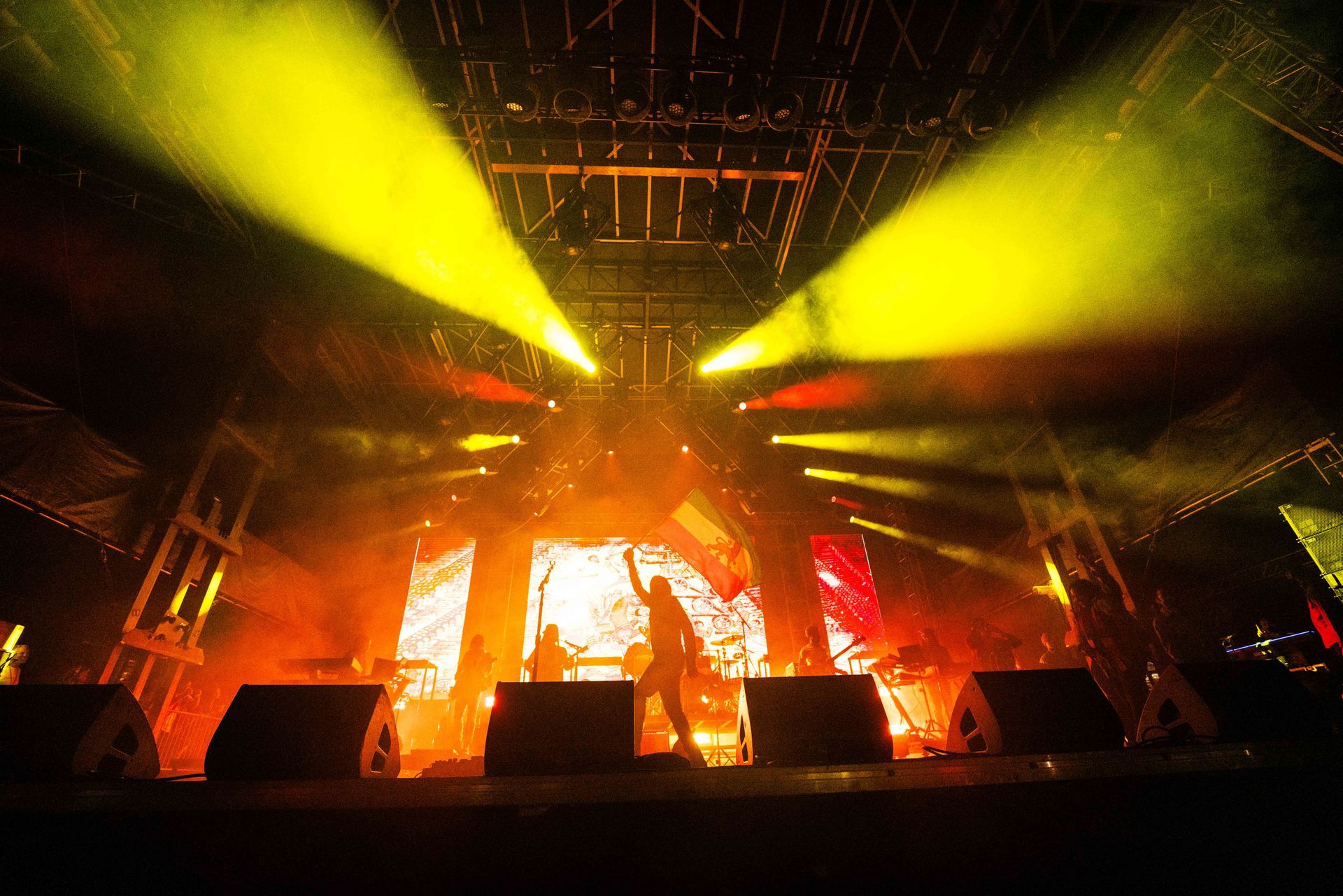 A stage with a lot of lights on it and smoke coming out of it.