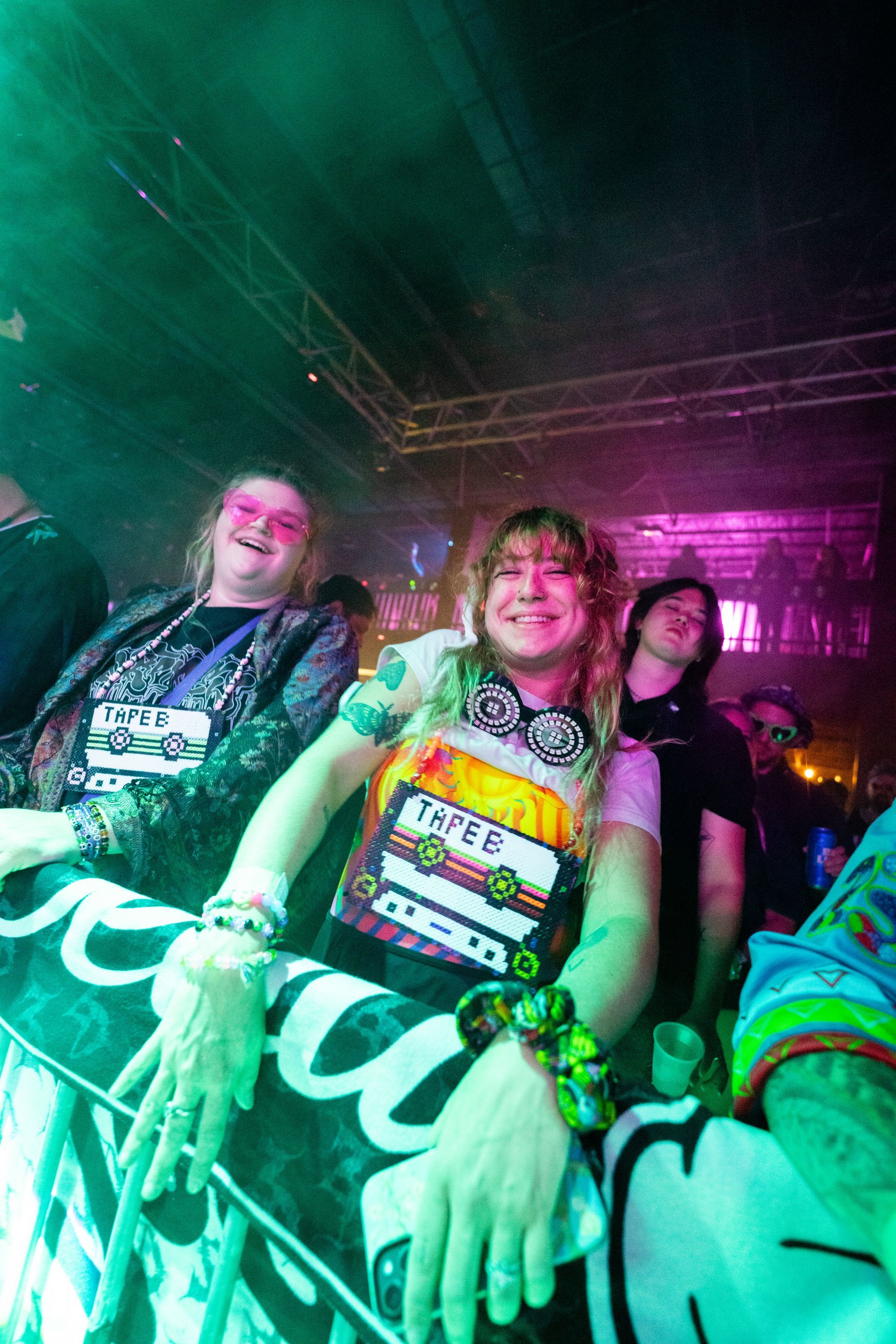 A group of people are sitting in a crowd at a concert.