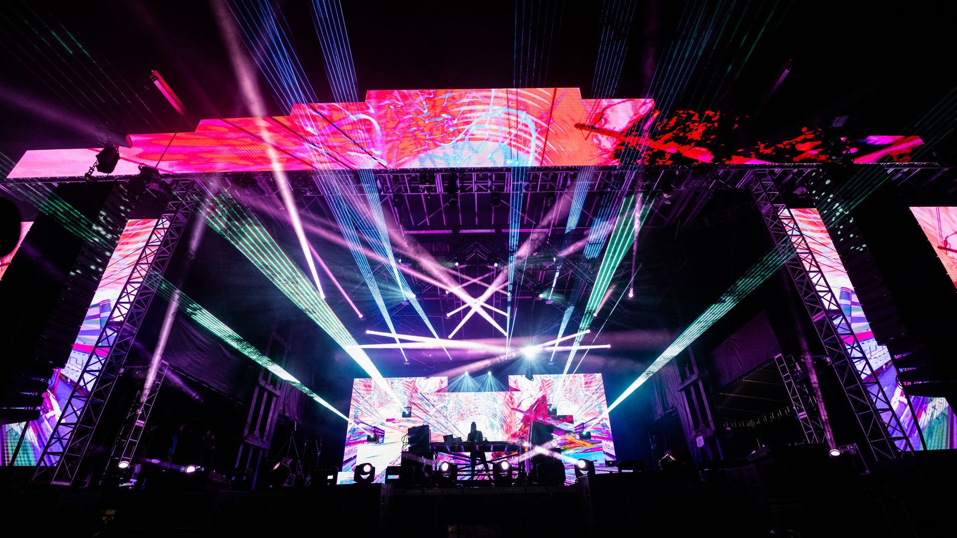 A large stage with a lot of lights on it at a concert.