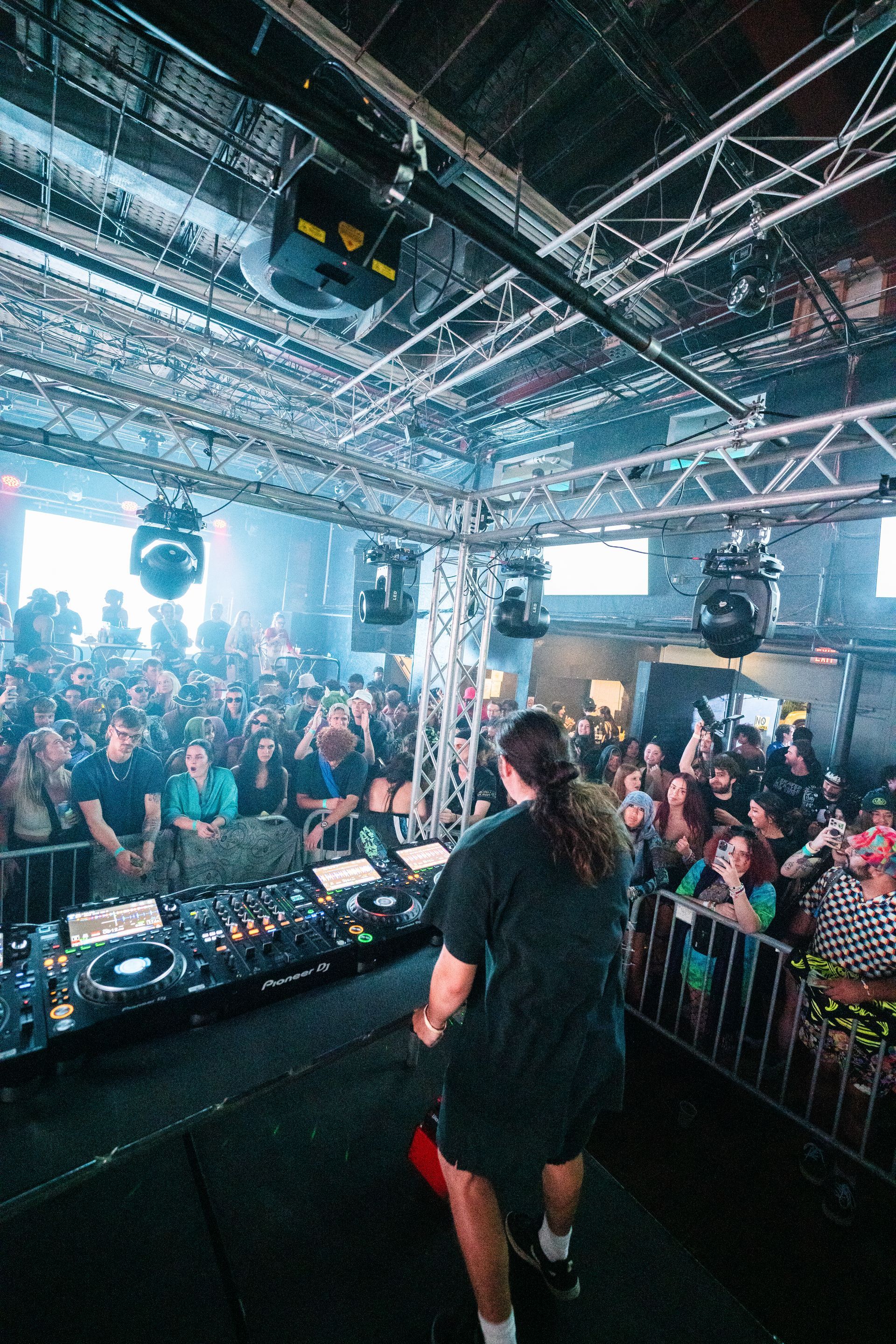 A man is standing on a stage in front of a crowd at a concert.