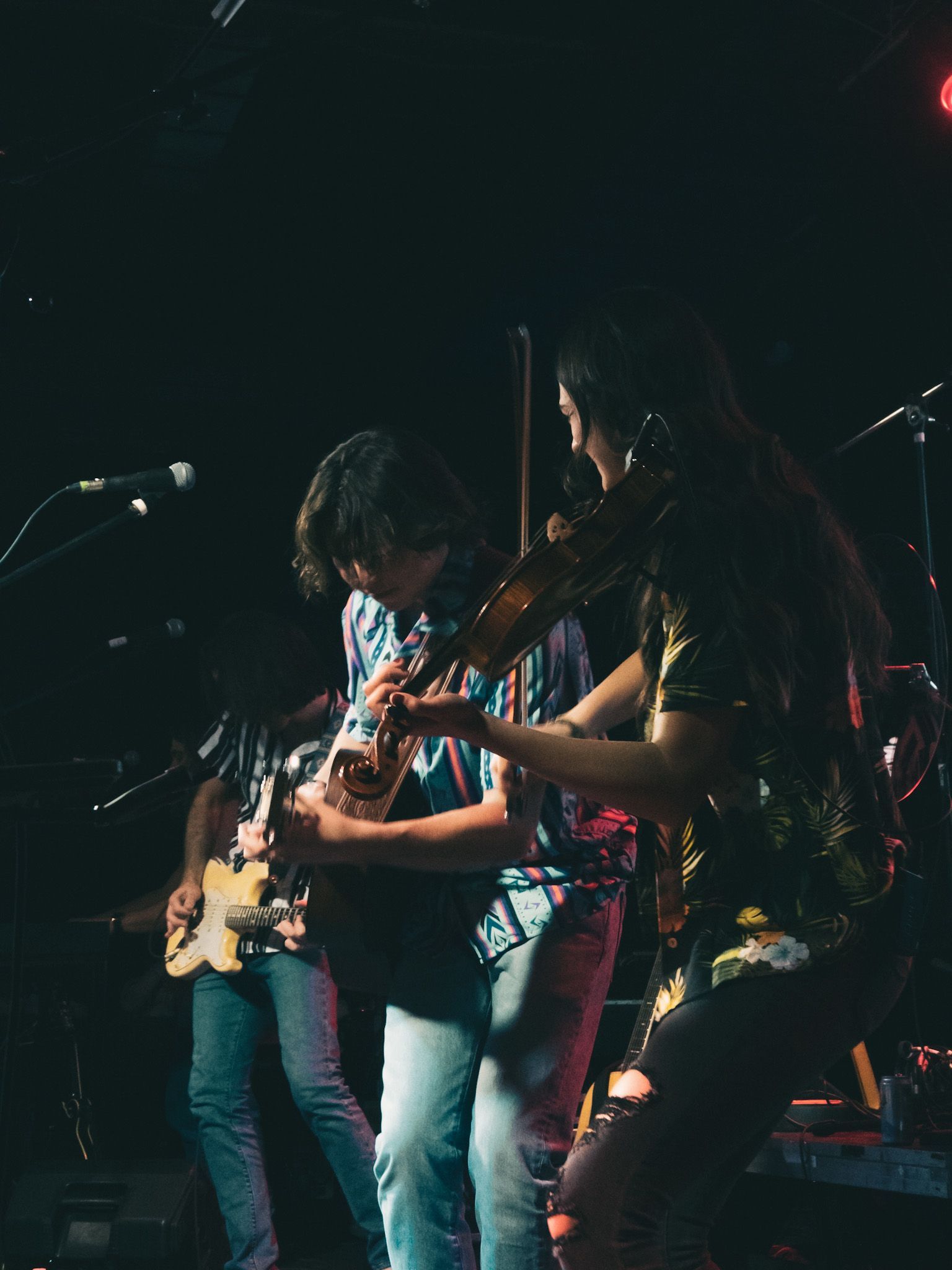 A group of people are playing musical instruments on a stage.
