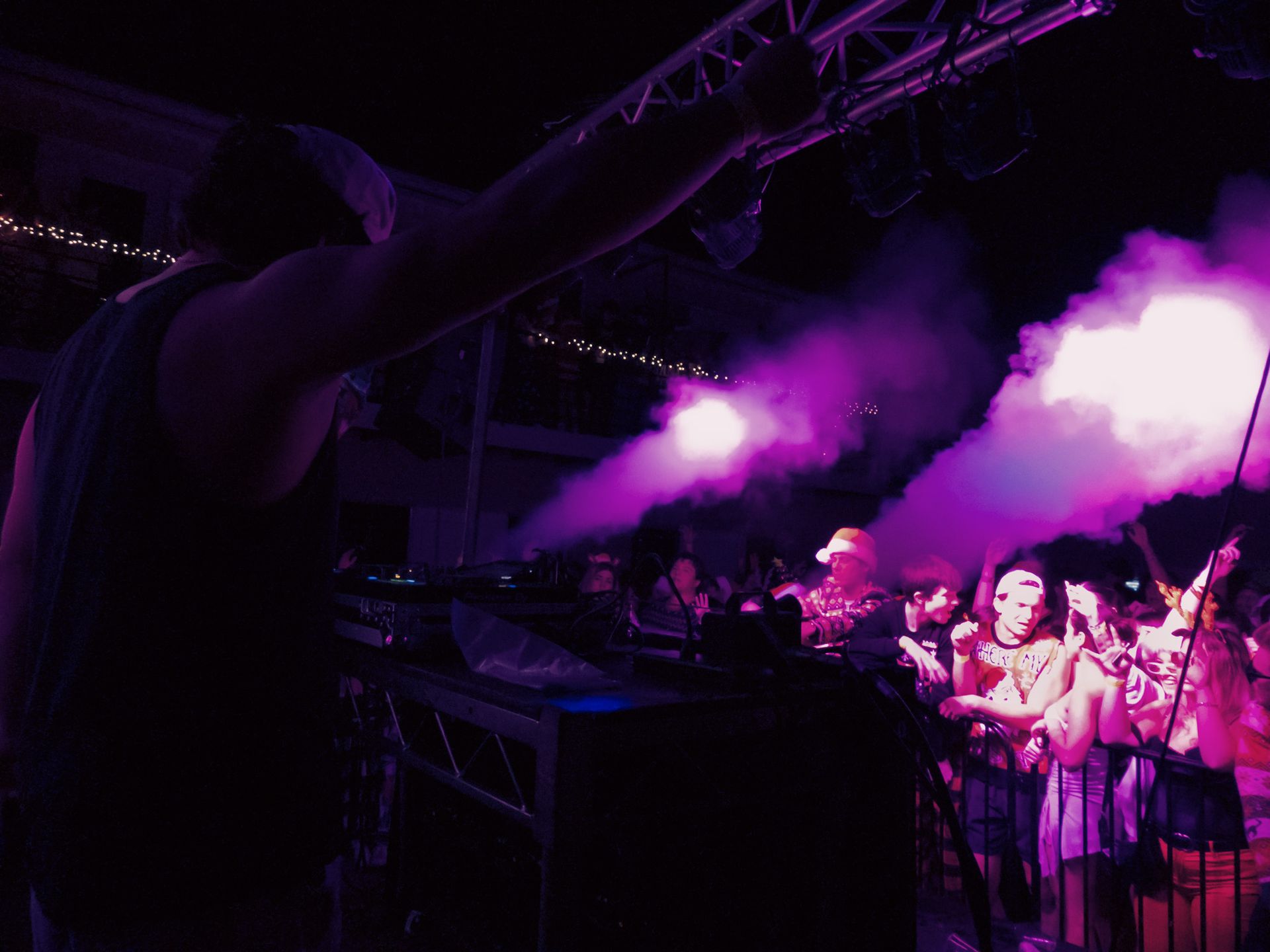 A man is standing in front of a crowd of people at a concert.