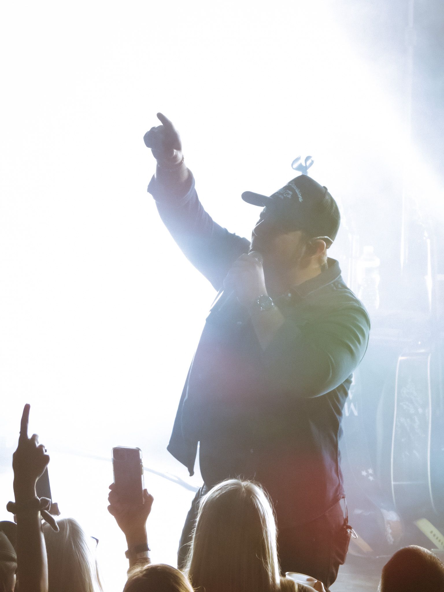 A man singing into a microphone in front of a crowd