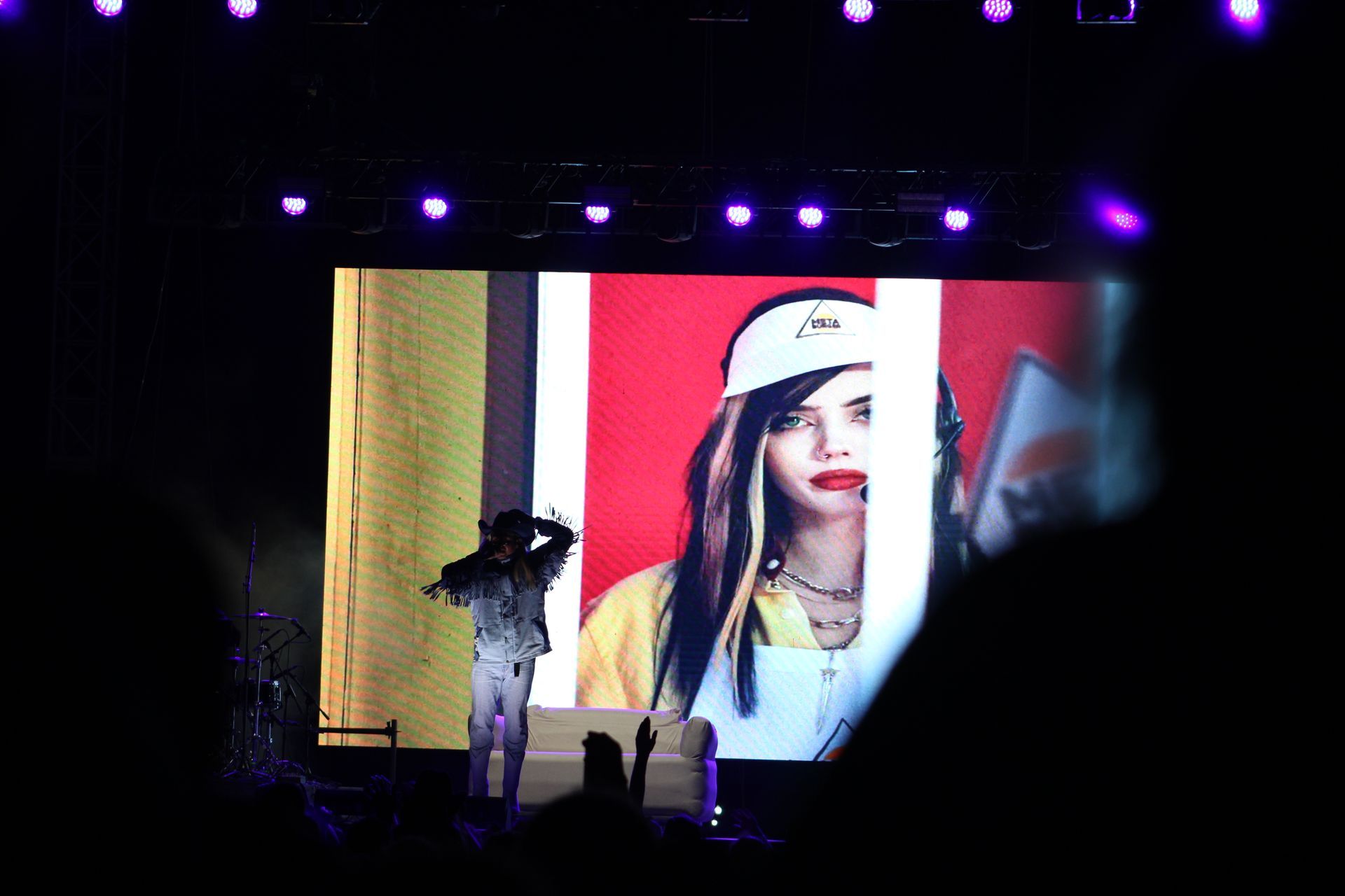 A large screen with a picture of a woman on it