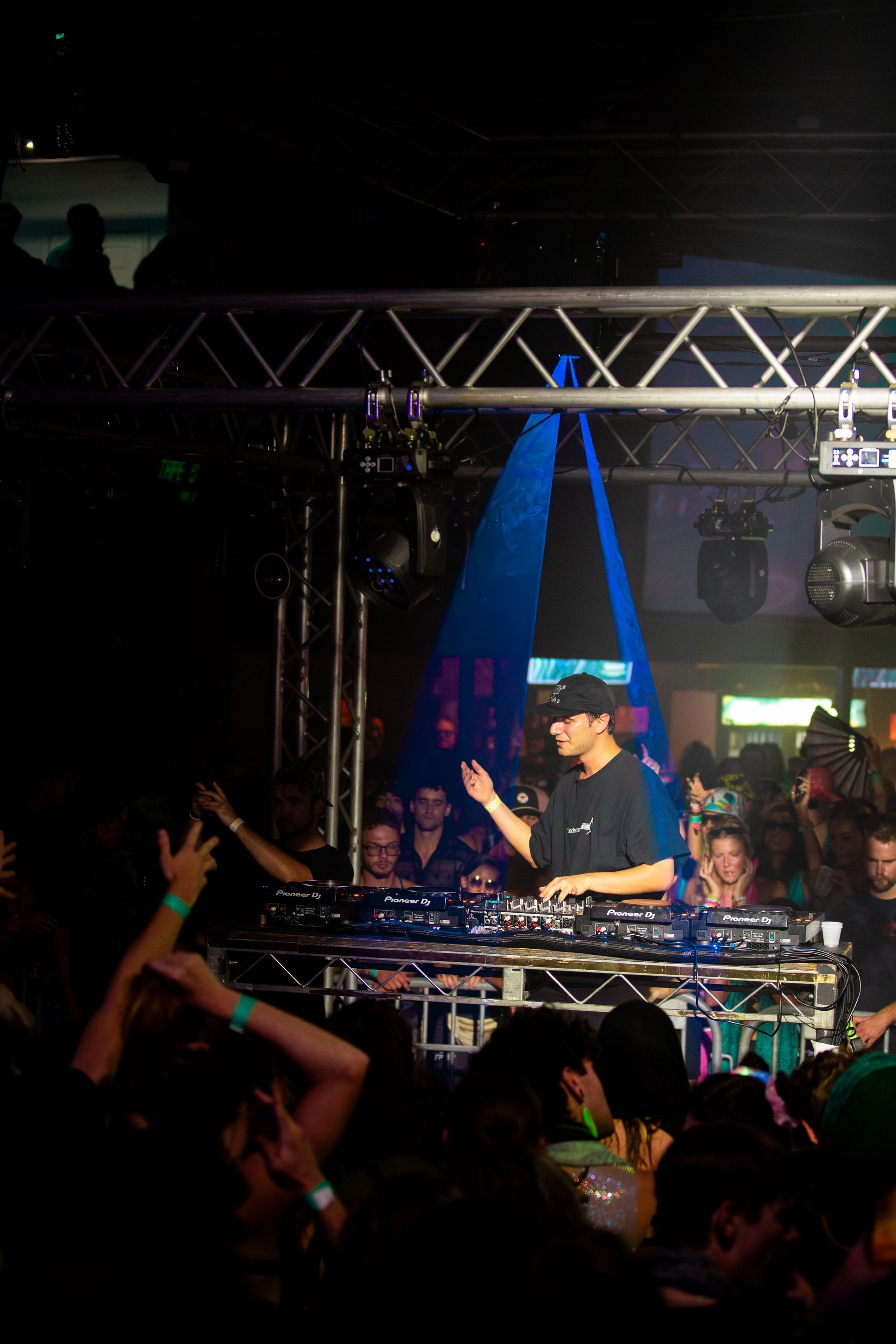 A man is playing music on a stage in front of a crowd.