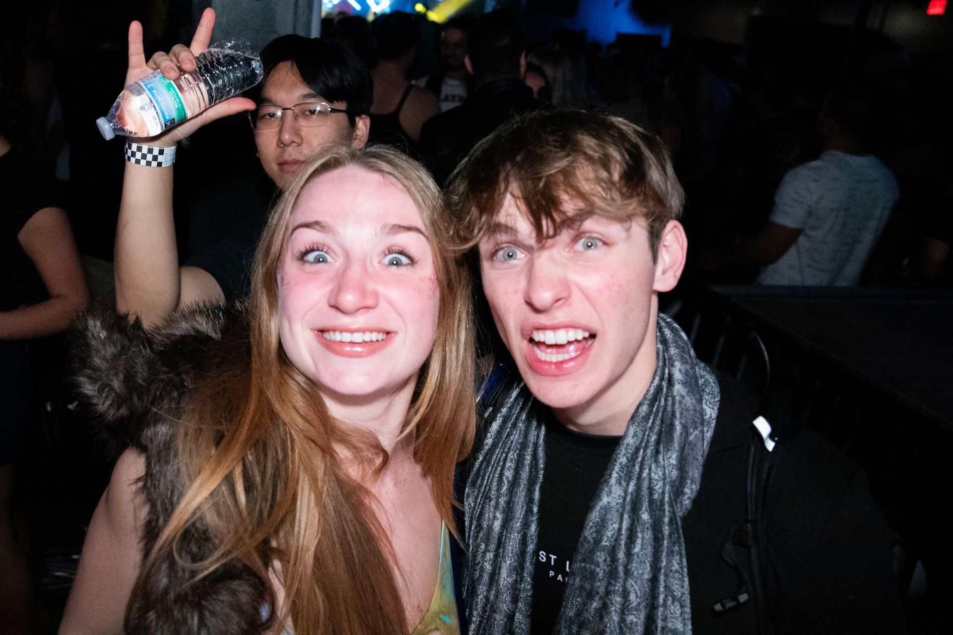 A man and a woman are posing for a picture at a party.