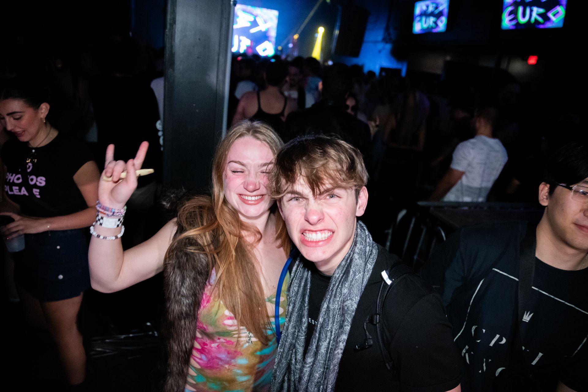 A man and a woman are posing for a picture at a party.