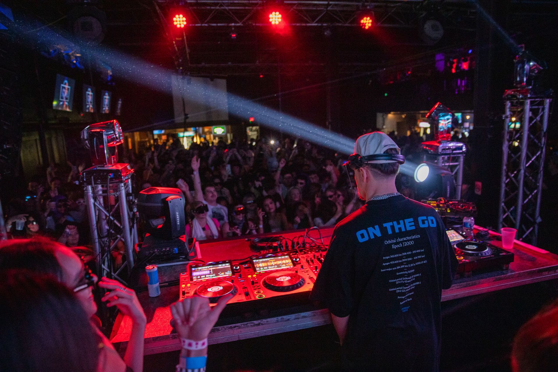 A dj is playing music in front of a crowd at a concert.