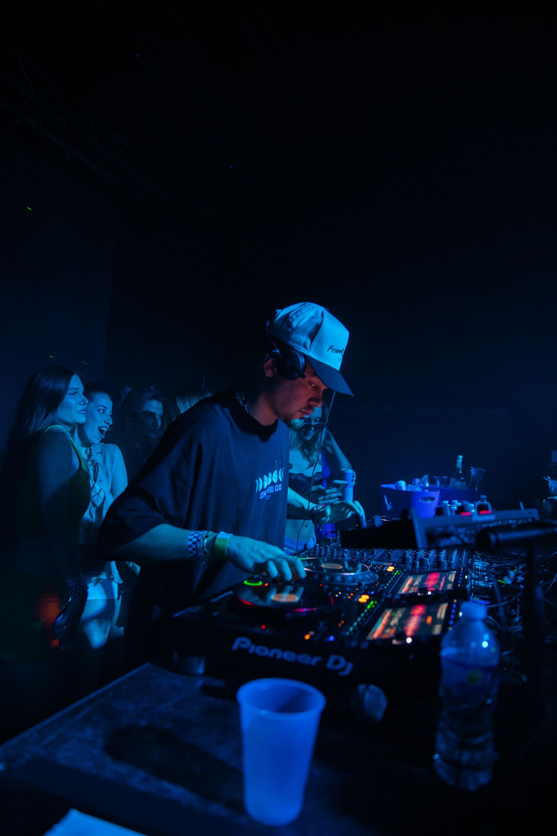 A dj is playing music in a dark room