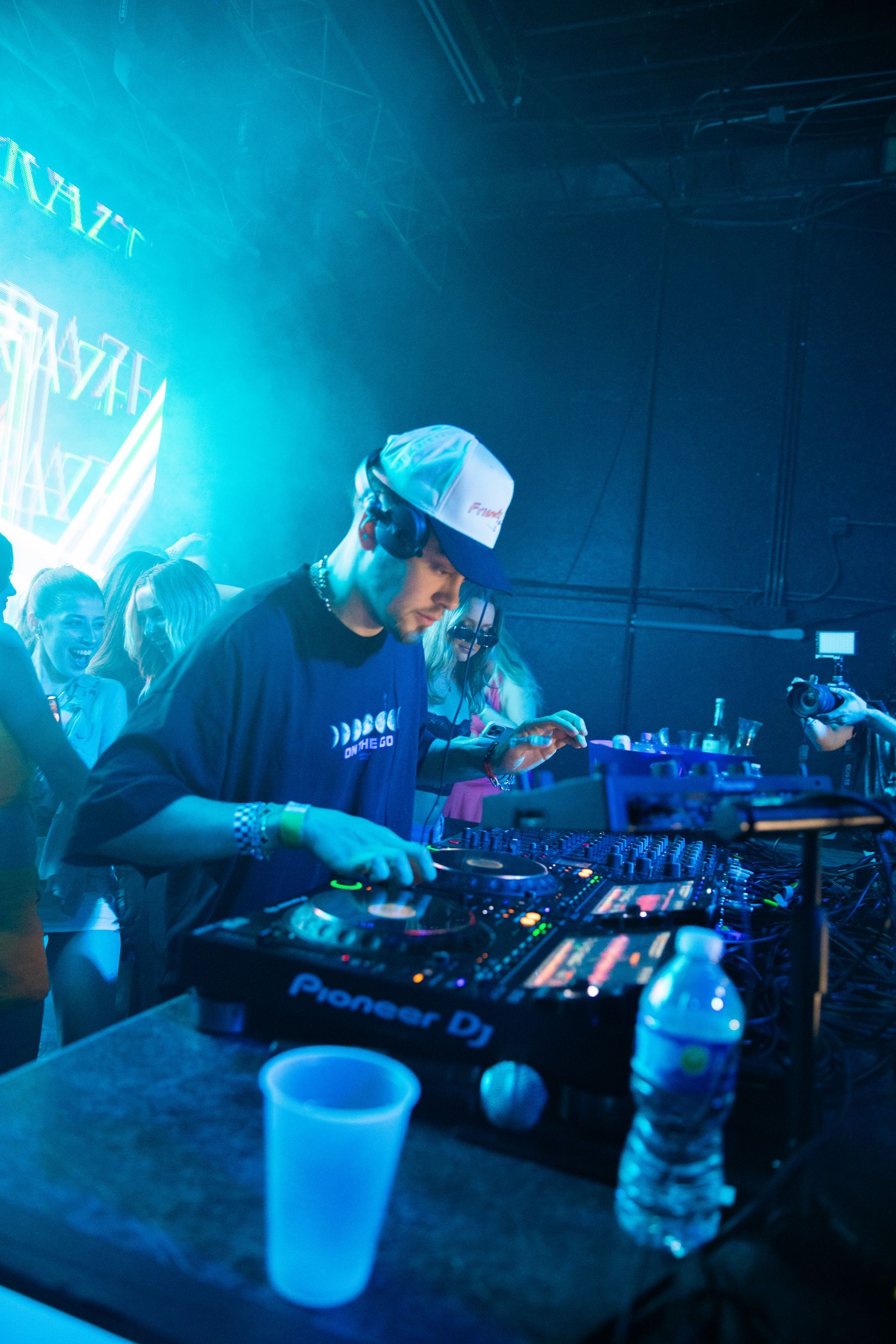 A man is playing music on a pioneer dj mixer