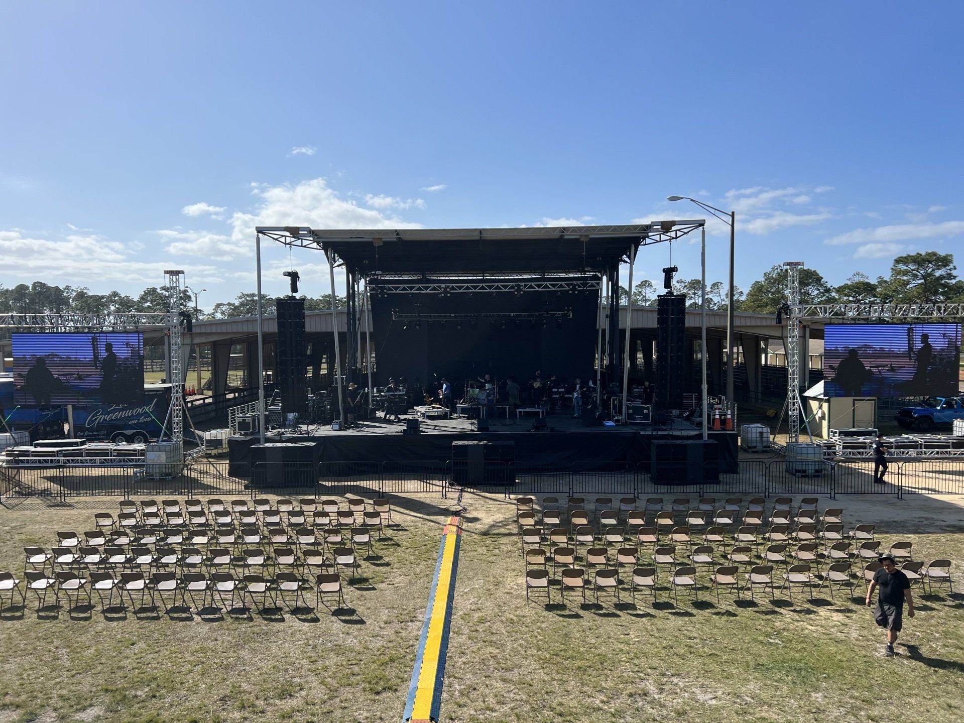 An aerial view of a large stage with rows of chairs in front of it.