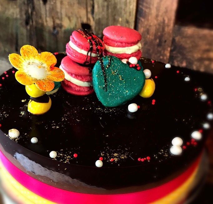 A cake with macarons and a heart on top — My Rainbow Bakery, Cafe & Catering in Cannonvale, QLD