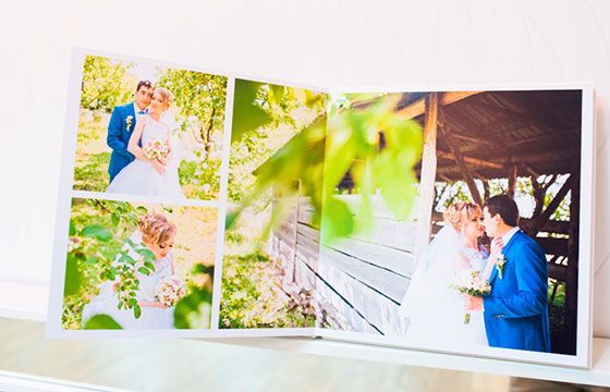 Wedding photo album with three bright photos of a couple outdoors and under a pavilion