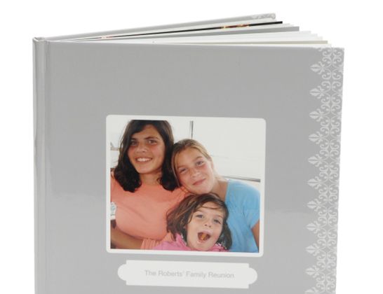 Gray family photo album with a smiling cover photo and lace-patterned spine