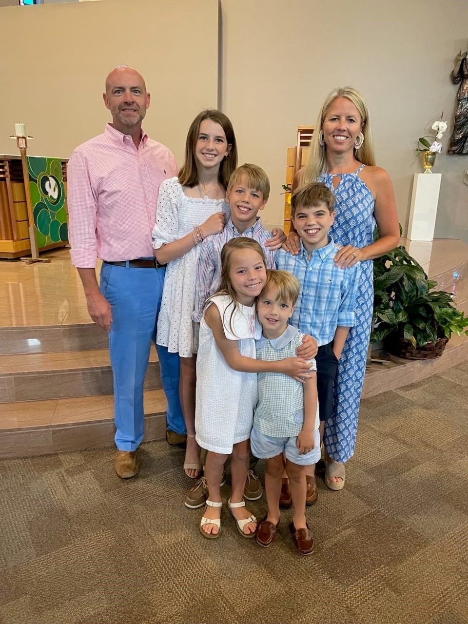 A family is posing for a picture in a church.