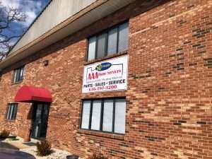 Brick storefront with red awning and sign for a pest-control service