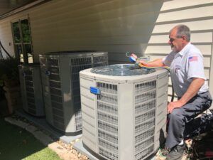 Preparing for Fall: Home Heating 4 AAA Professional performing a furnace check