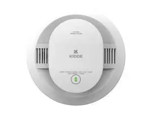 White Kidde smoke and carbon monoxide alarm with green test button on a wall.