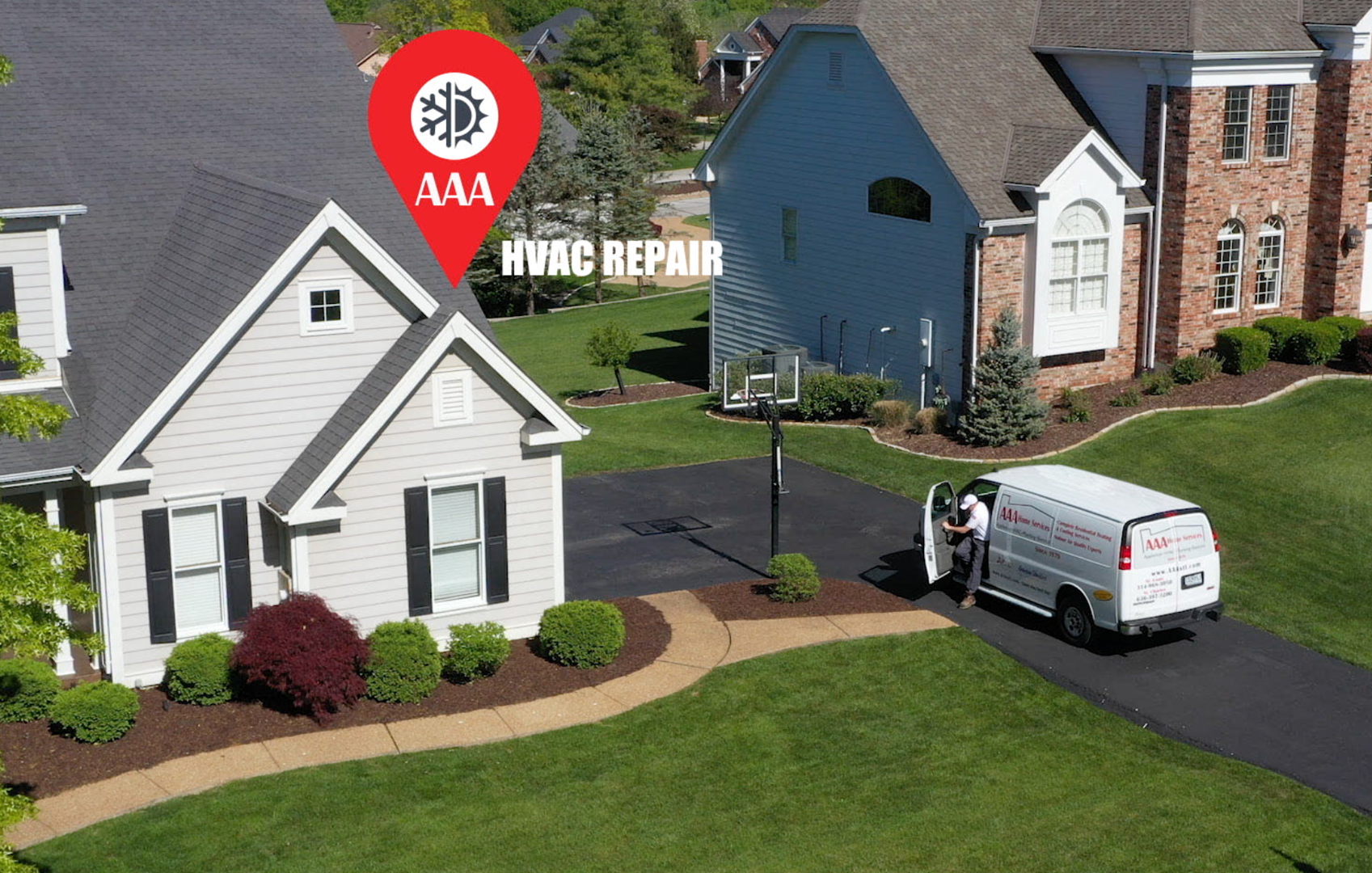 White house with a roof and siding repair ad, featuring a red logo and a work van in the driveway.